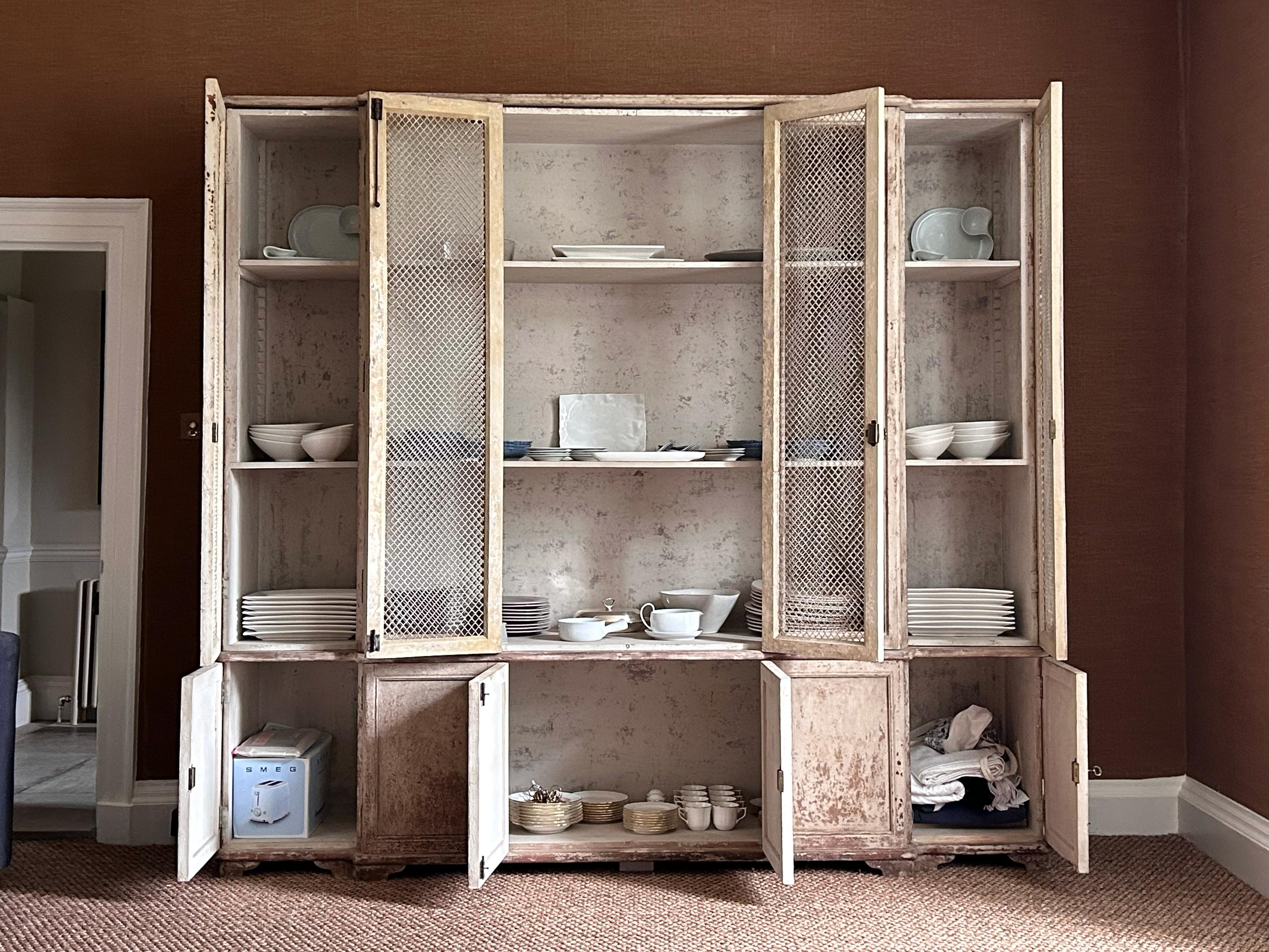 A continental painted pine breakfront cupboard, dresser or bookcase, late 18C/early 19C. 

Stock ref. #2366

In good sturdy order with beautifully worn painted exterior. Later refurbished shelved interior. Some original forged iron bolts with other