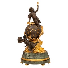 Horloge continentale en bronze patiné et bronze doré, signée Imperial