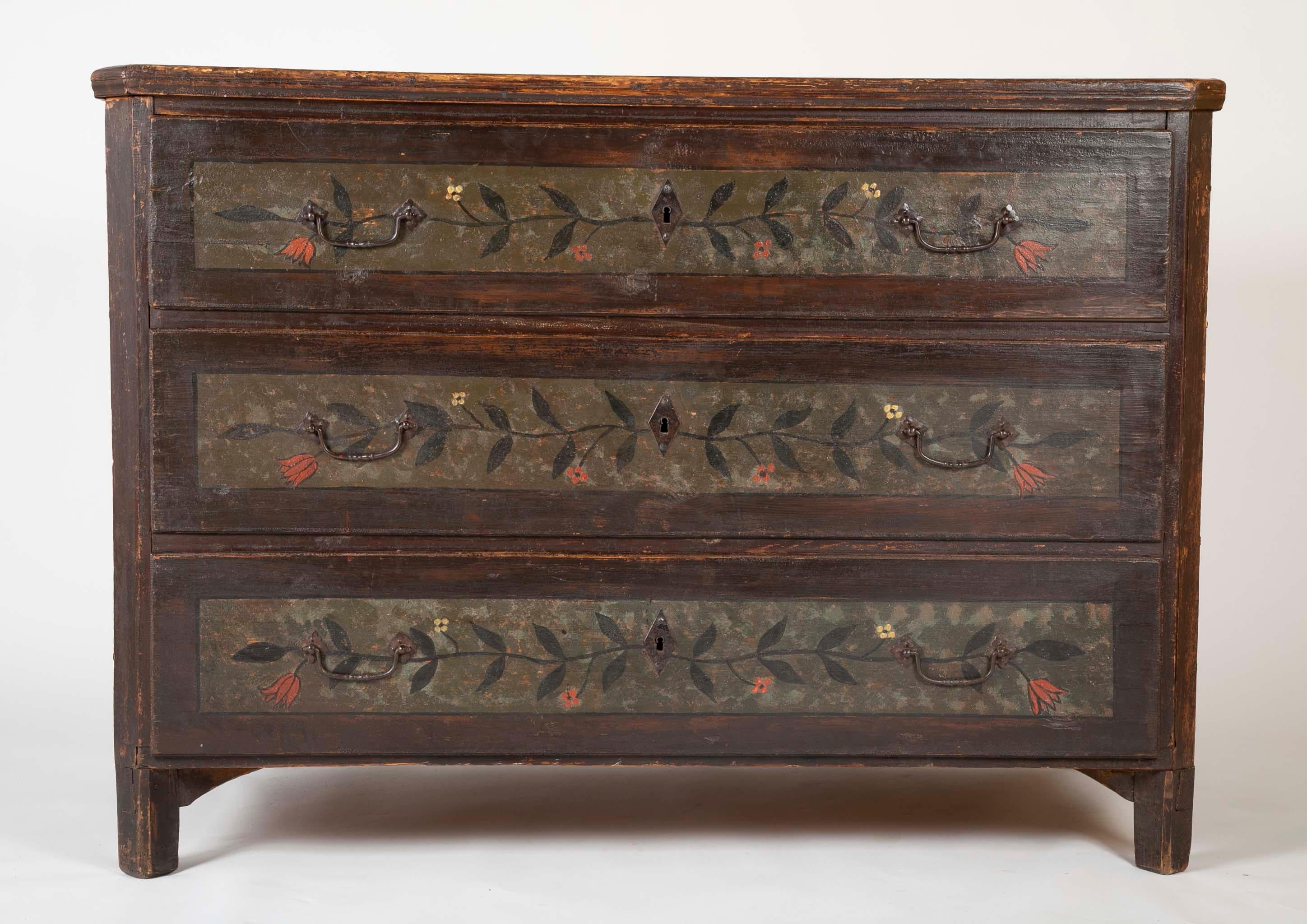A three-drawer Continental pine chest with poly-chrome floral decoration. Possibly Norwegian.