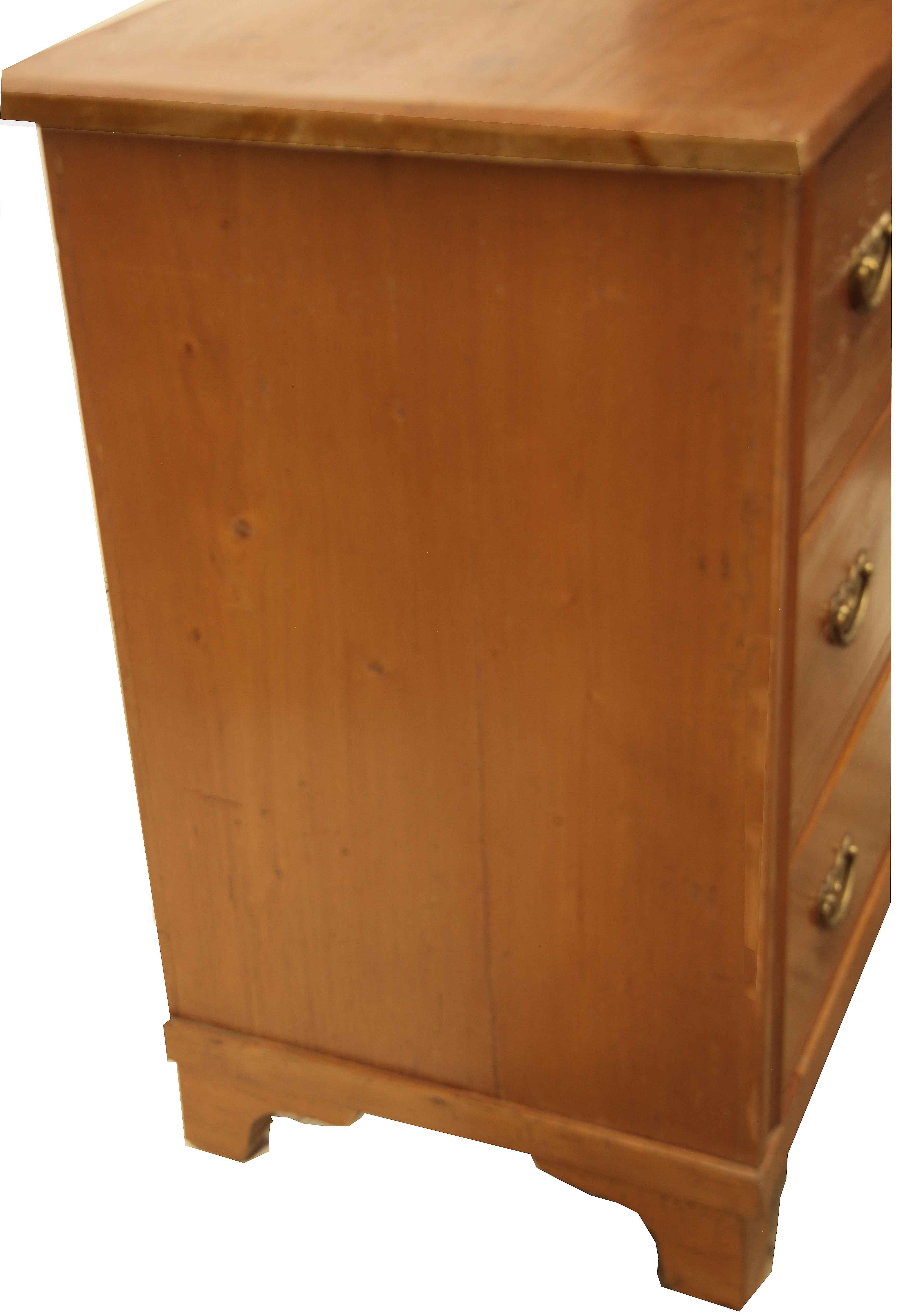 Continental pine three drawer chest, with a pleasant honey color all over, the top has angled front and side edges, drawer sides and bottoms are very thick , typical for this period and location in Europe, the brass pulls not original. The concave