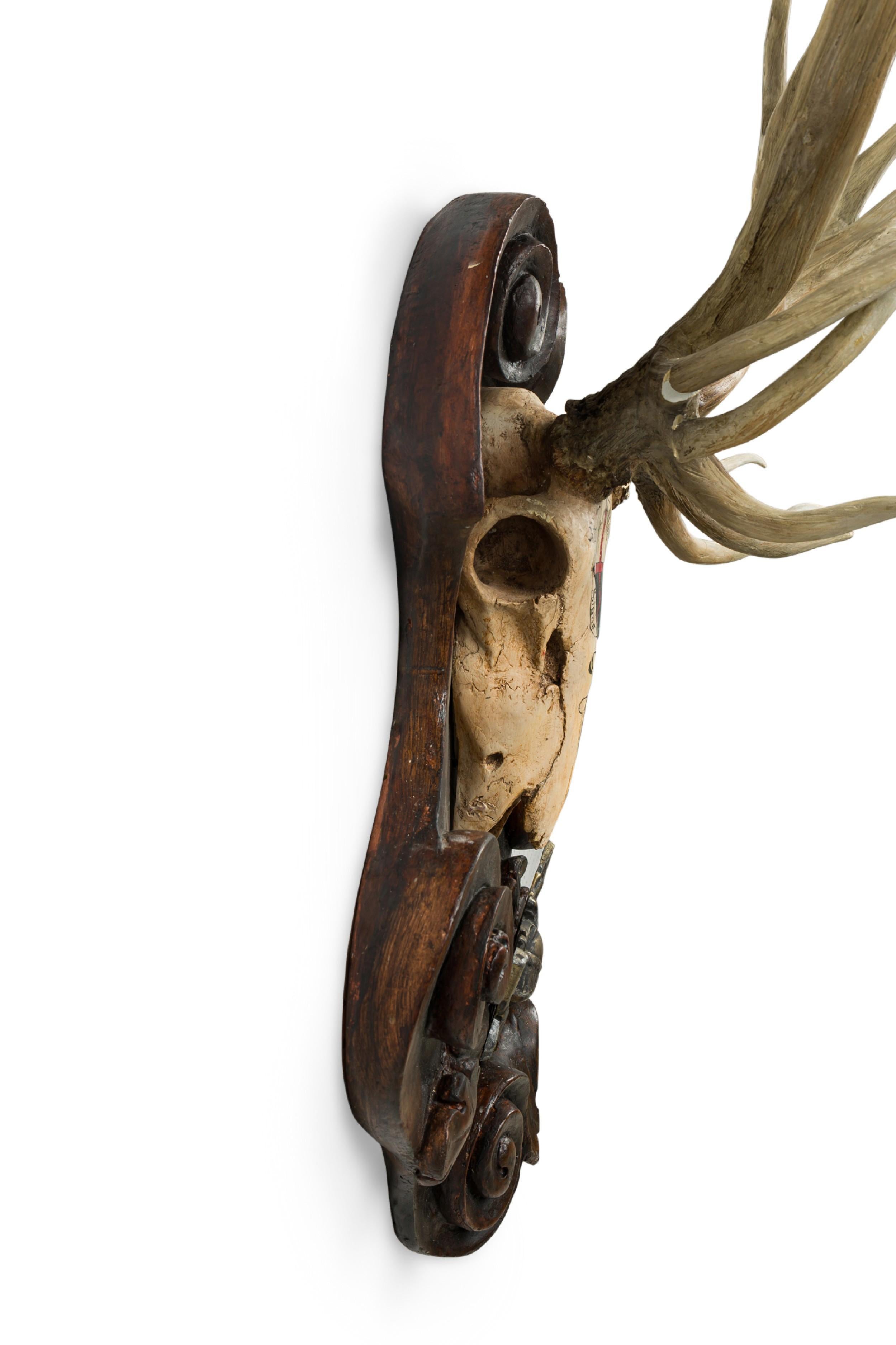 Continental Rustic Wall Plaque of Elk Skull with Cross Insignia Painted For Sale 1