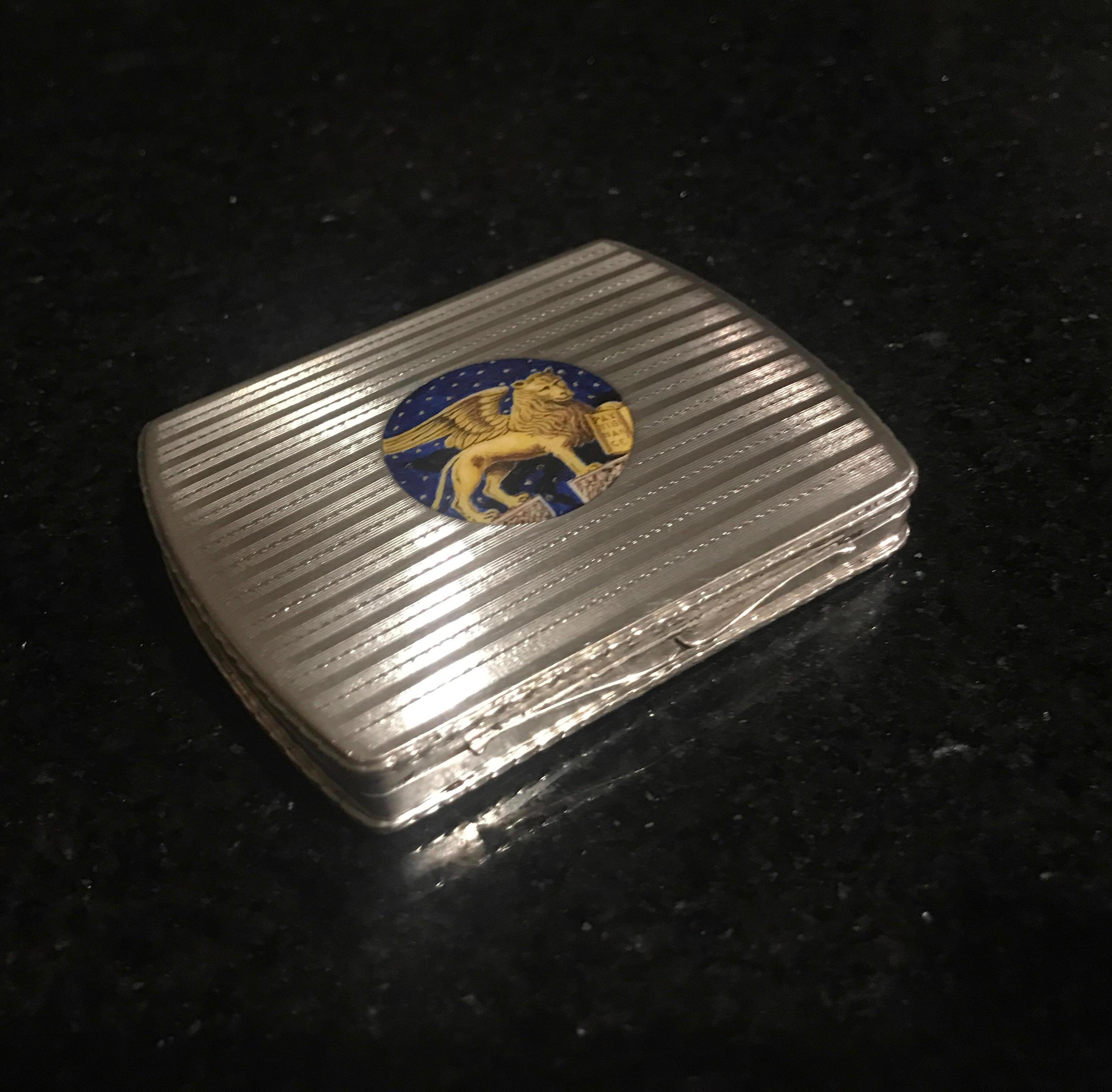 Solid continental silver hinged calling card or possibly cigarette case with enamel cartouch of the lion of Saint Mark. The 800 silver case with machine tooled pattern on the top and bottom with a gold wash on the interior. The inside is stamped