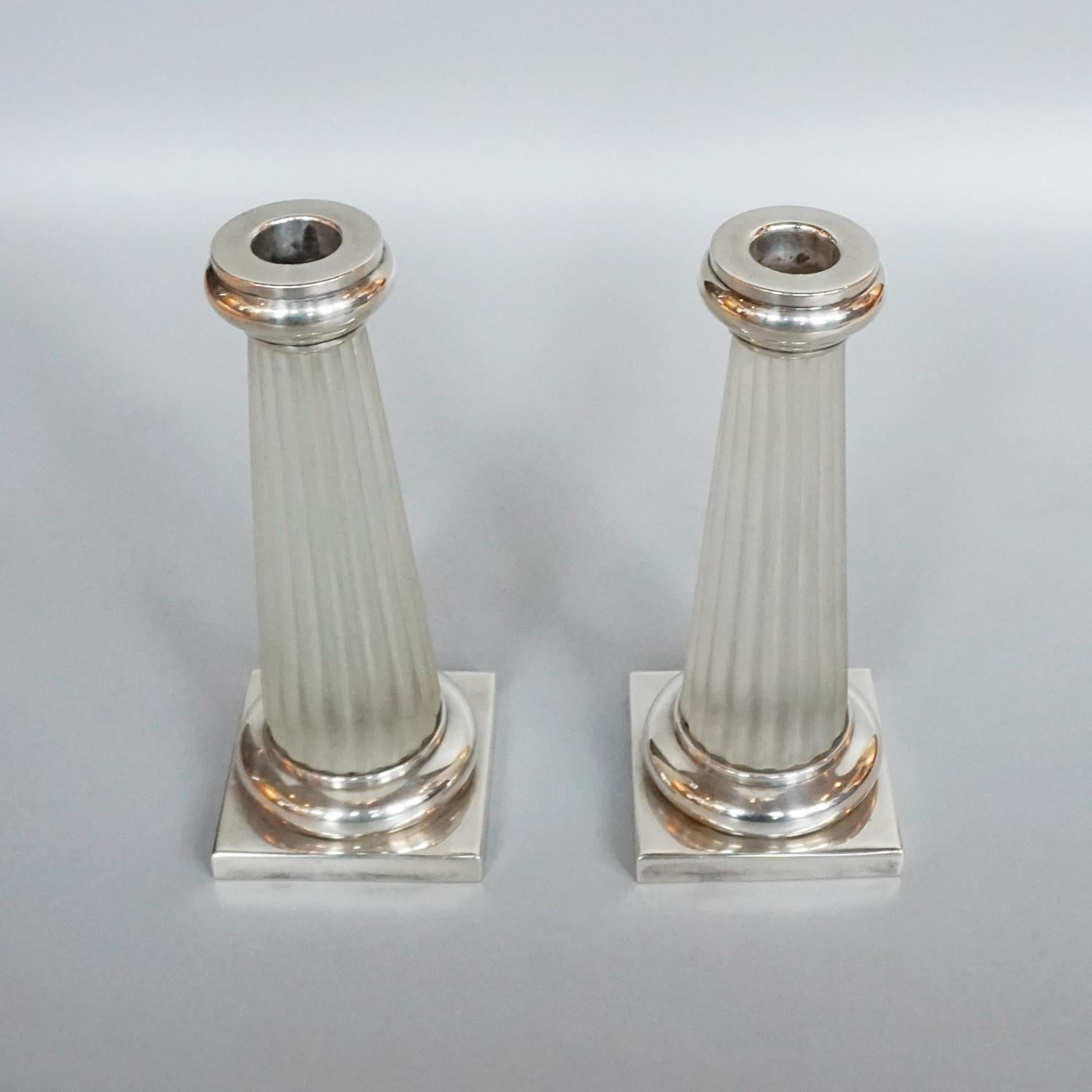 A pair of Art Deco candlesticks. Continental silver and glass. Stamped underneath.

Dimensions: H 21cm W 8cm D 8cm.

Origin: French.

Date: 1934.

Item Number: 1201221.