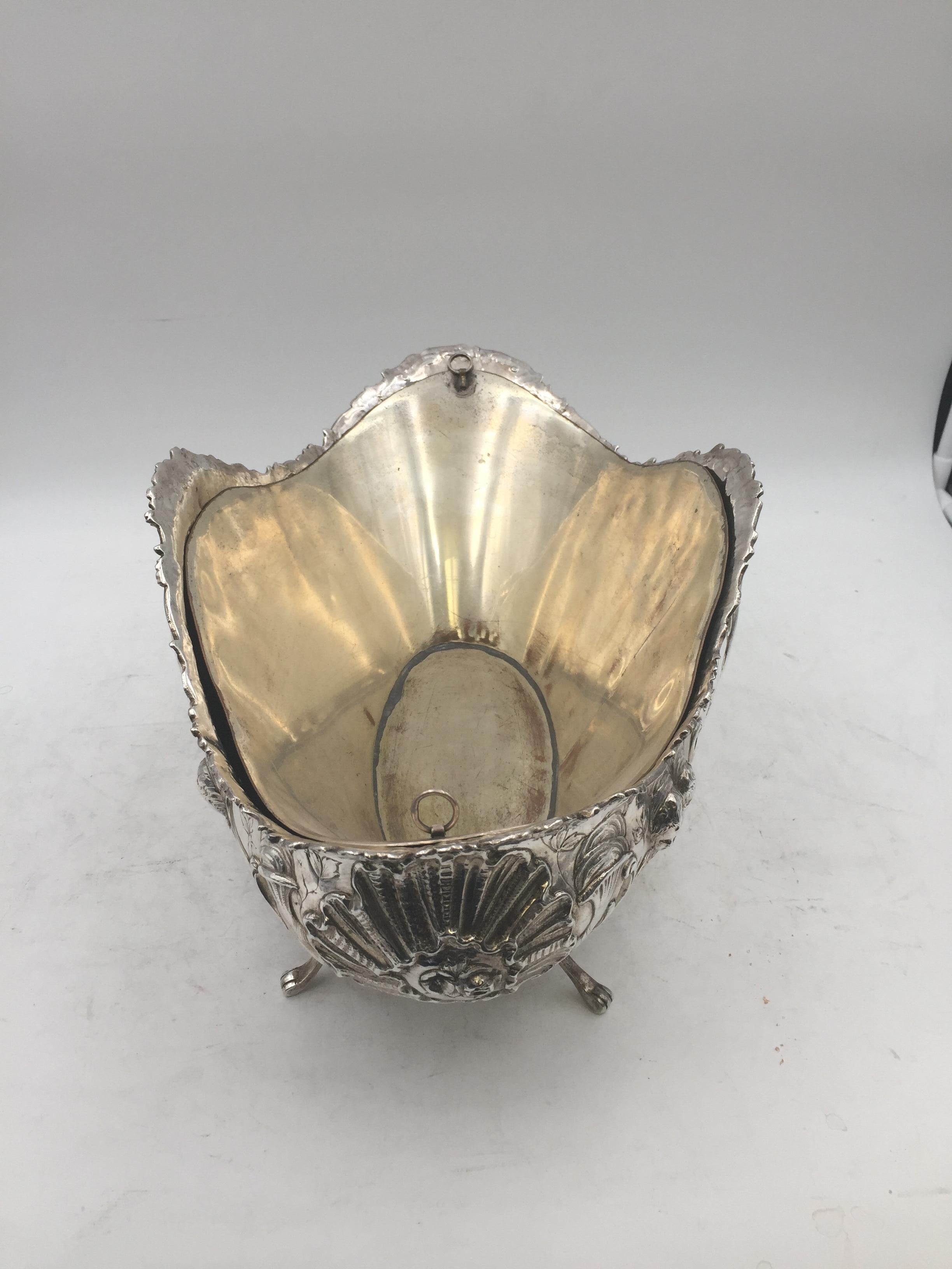 Continental silver repousse bowl, circa 1900. The center of the bowl has a beautiful cherub/putti scene. Rose swags and foliate scrolls to the inner pierced walls. Monogrammed and dated Oct. 19th, 1928. Weight is 40.3 ozt without insert. 8 in tall,