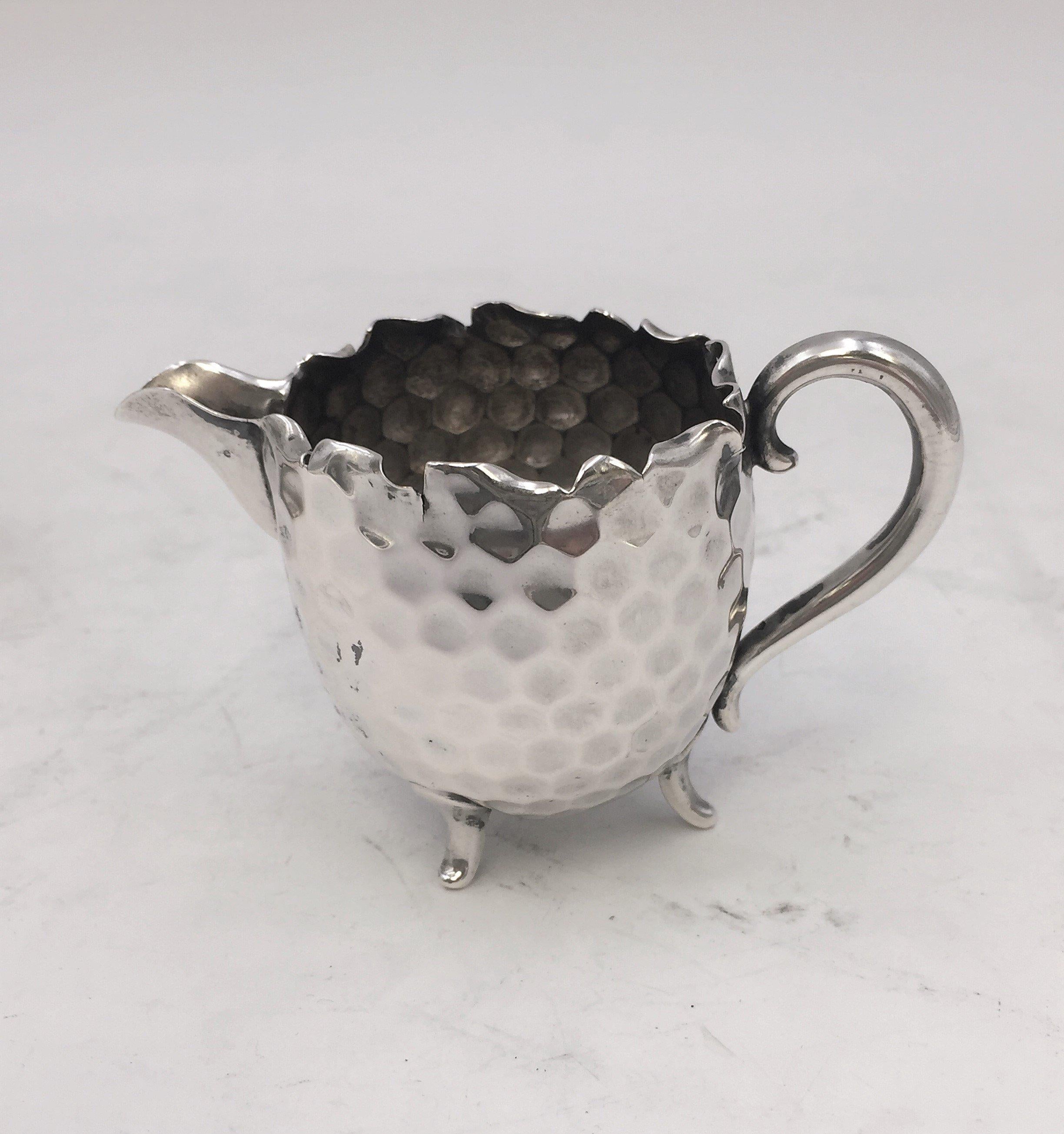 Hand hammered tea / coffee service in 800 silver by famed German silversmith Hugo Böhm in modernist Bauhaus style consisting of:

Pot, 6'' from arm to spout and 5'' high
Sugar bowl, 5'' in width and 1 2/3'' in height
Creamer 3 1/4'' from arm to