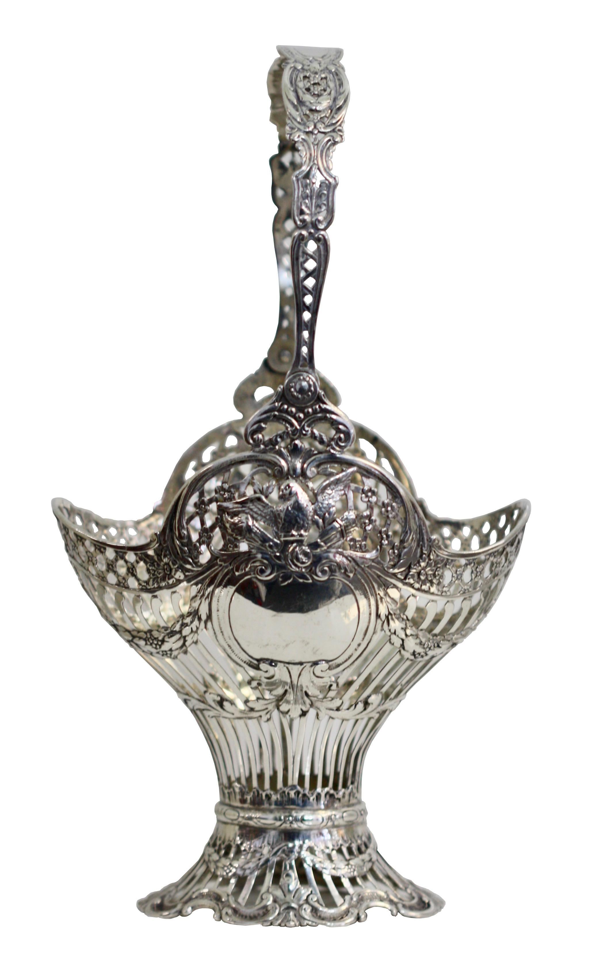 Fine Continental silver pierced foliate design basket each side with a dove above a vacant shield, applied with a swing handle
Measures: Width 5.5 in. (14 cm.)
Depth 3.93 in. (10 cm.)
Height 10.23 in. (26 cm.)
Weighing approximately 199 grams, 6
