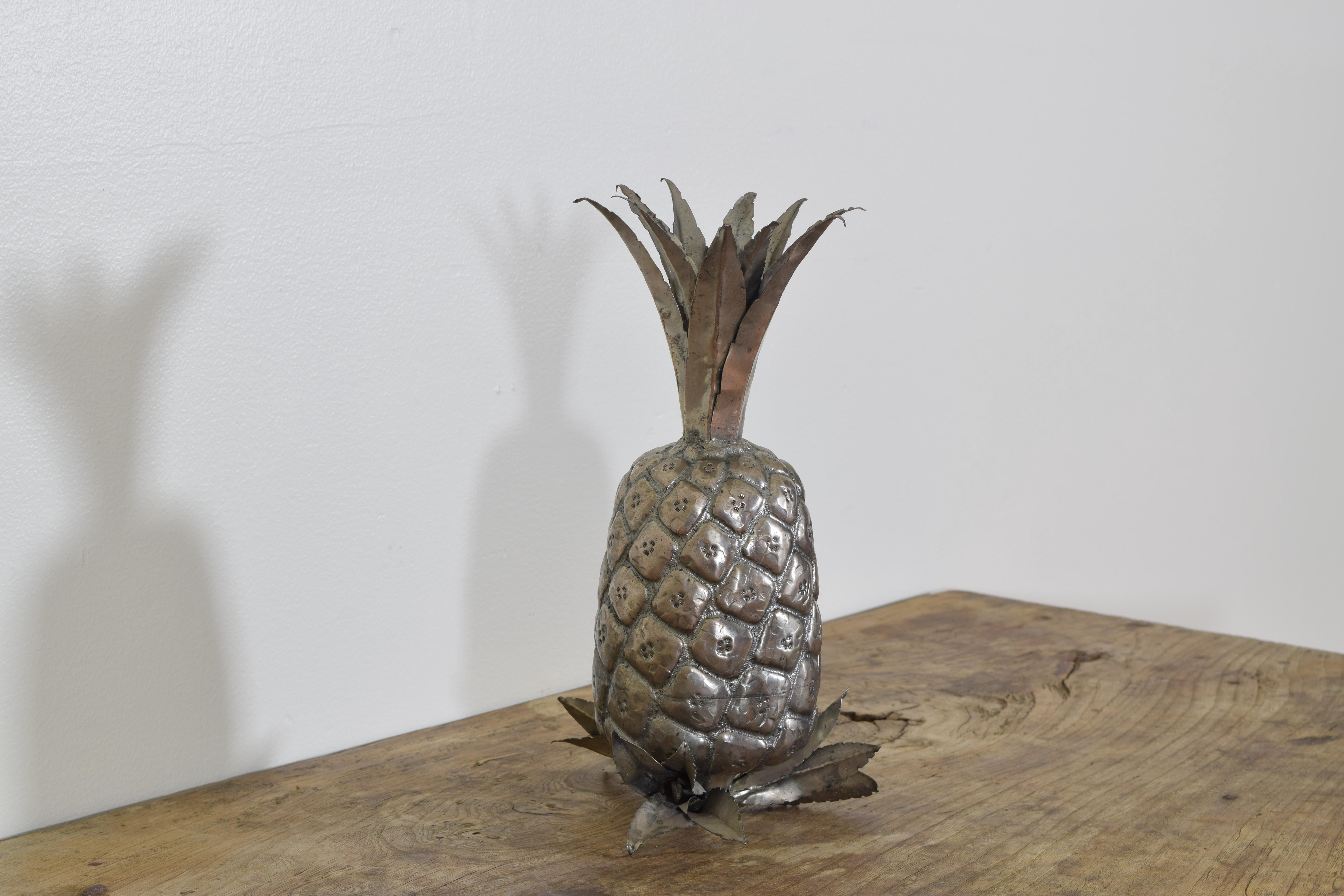 The miniature pineapple well cast and plated in silver, with a leaf-form lower section serving as a stand.