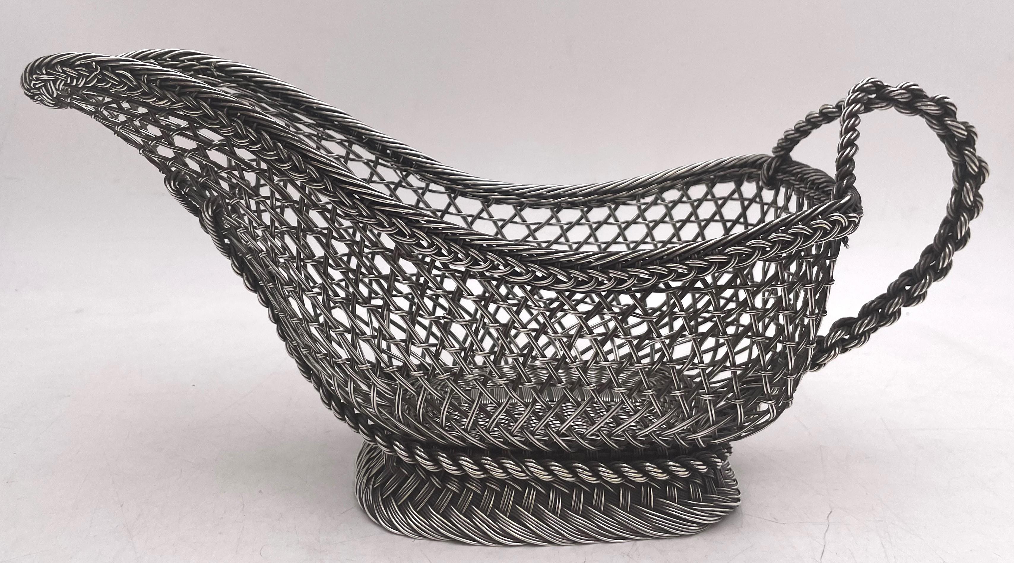 Continental silver wine caddy basket, made in Europe in the 19th century with a fishnet style design. It measures 12 3/4'' by 4 1/4'' in depth by 6'' in height, weighs 19.7 troy ounces, and does not appear to be hallmarked but we guarantee that it