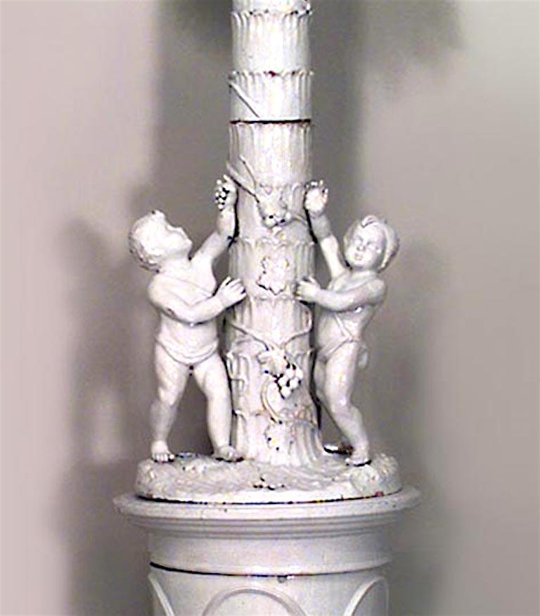 Continental Swedish-style (19th Century) white glazed terra cotta stove with palm tree design with 2 cupids.
