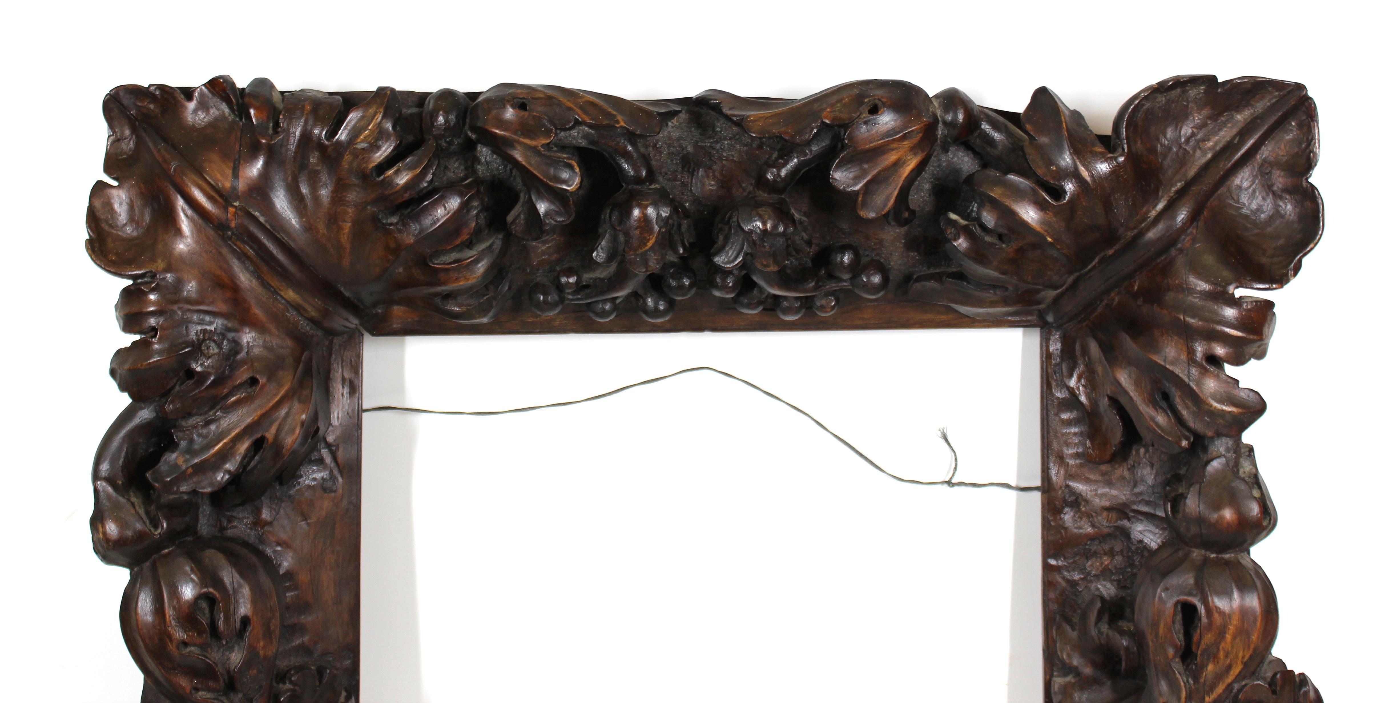 Continental tropical baroque heavy solid wood frame, carved by a master carver. The piece has elaborately carved opulent heavy foliage and was made during the 18th century in Europe. In remarkable antique condition with age-appropriate wear and use.