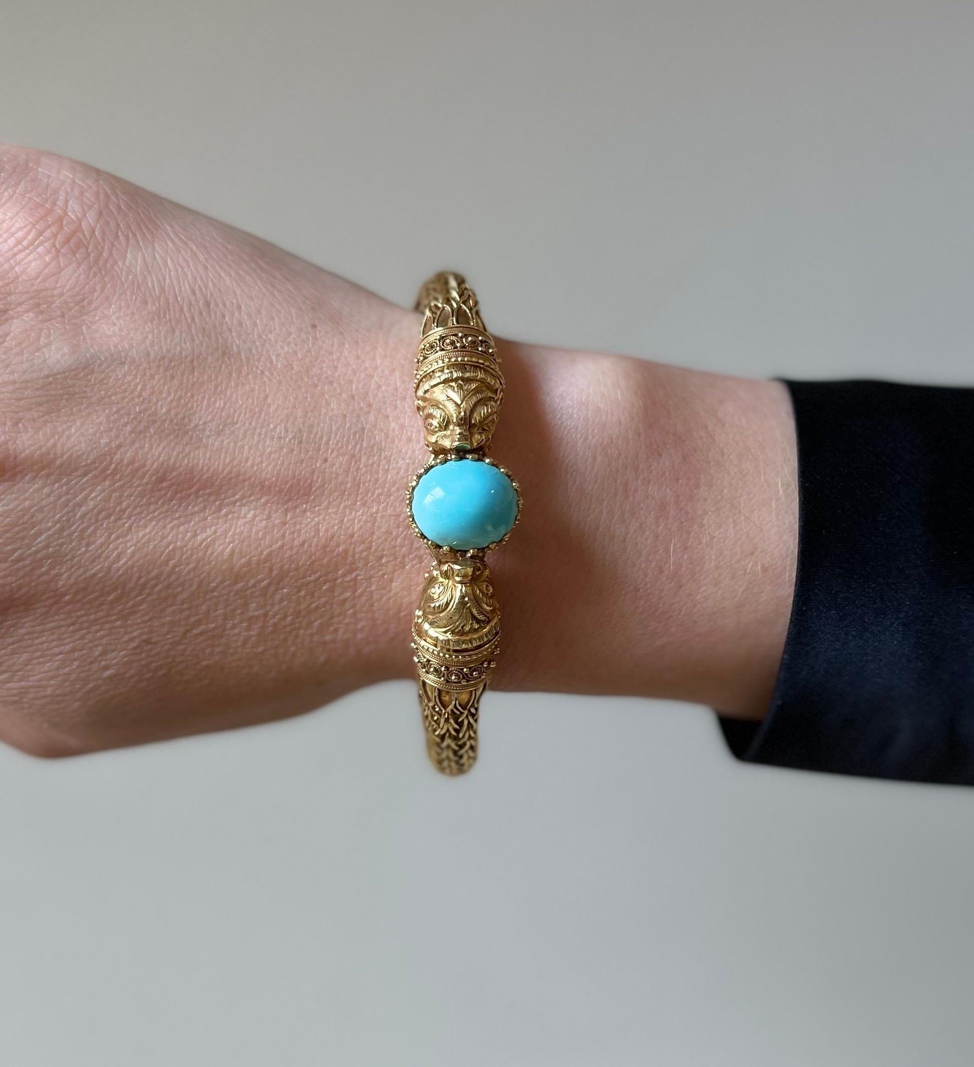 Impressive 18k yellow gold vintage bracelet, depicting chimera heads with a turquoise in the center, measuring 14mm x 12mm. Bracelet will fit an average wrist size 7