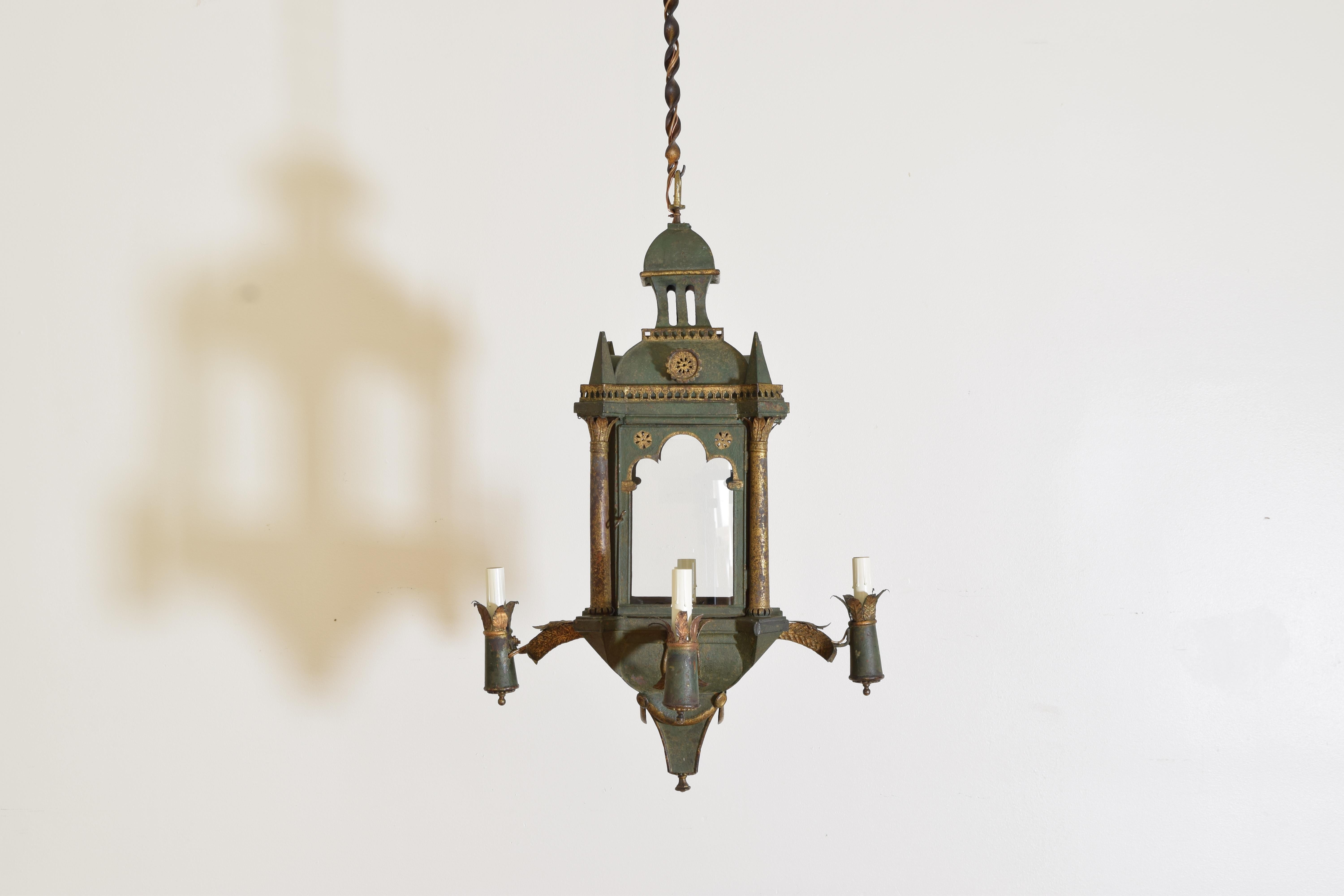 This unique painted and gilt tole lantern features one internal light accessed by a door as well as four arms with external lights, inspired by Venice with it’s trefoil arches and peaked turrets this lantern is a mix of styles and periods, newly