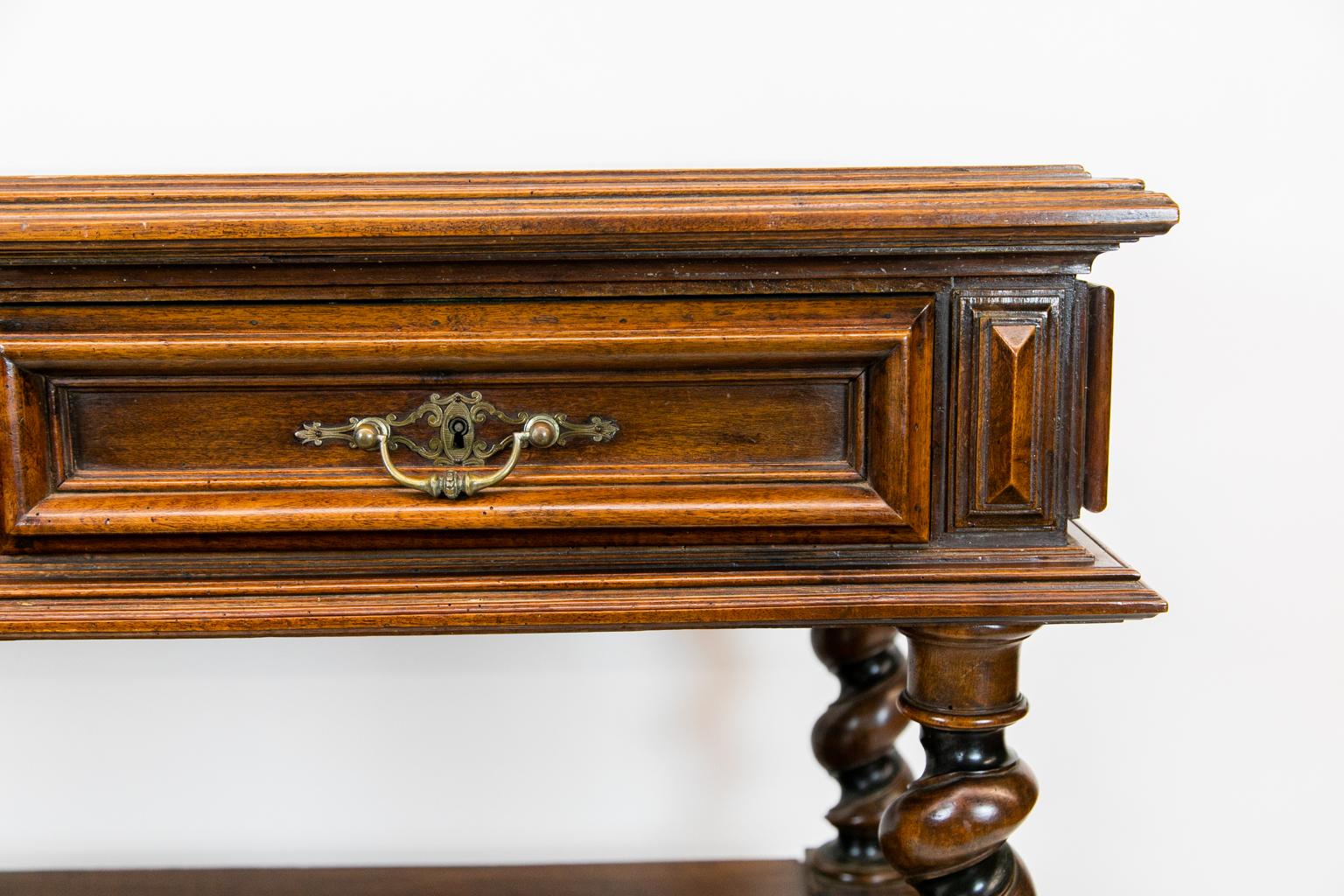 Continental walnut three-tiered barley twist shelf, with drawer fronts that are two inches thick, including the moldings with oversized interior locks. The top is paneled with a top molding of multiple shapes. There are beautifully shaped and