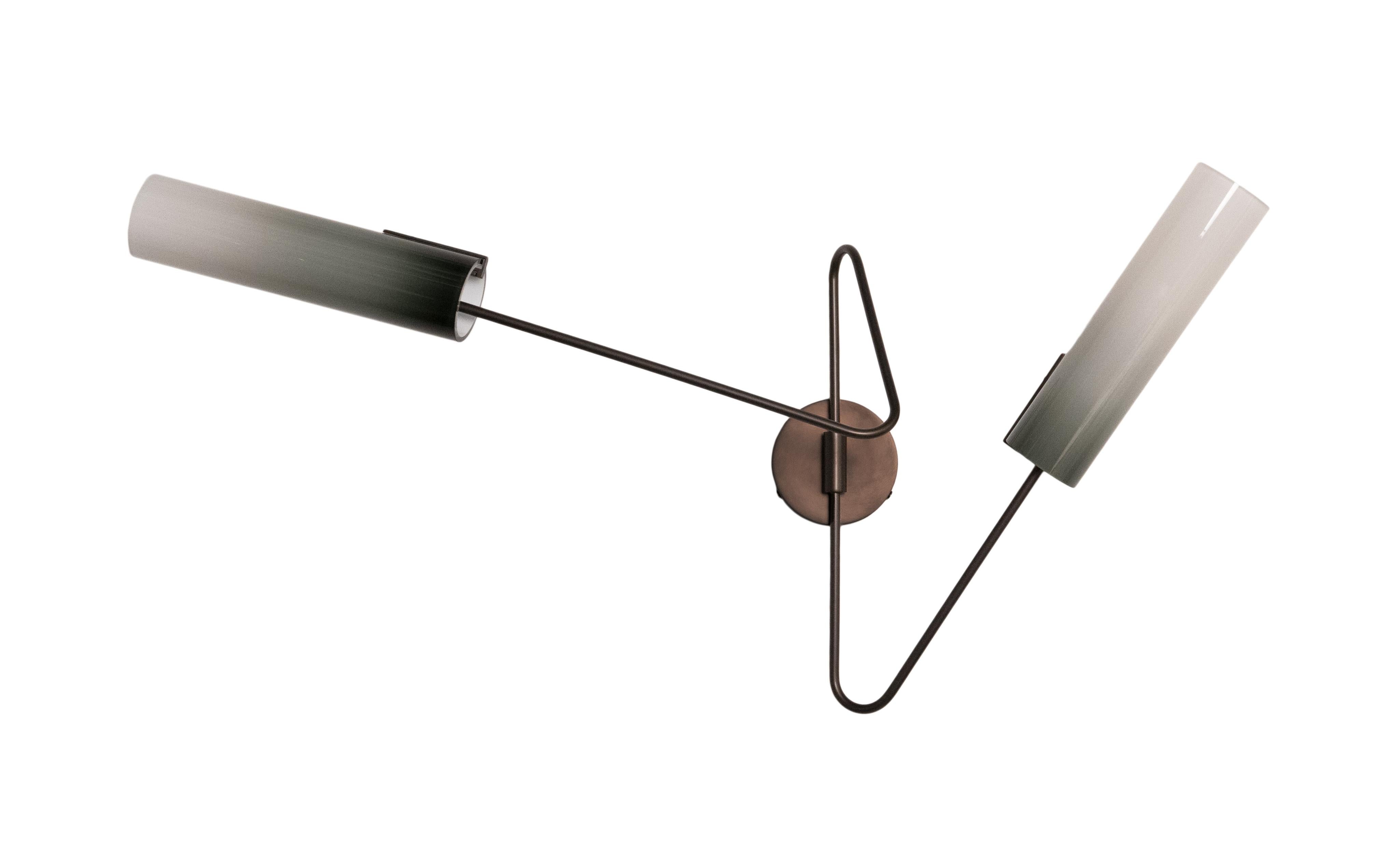 The Continuum collection was inspired by New York’s vibrant street art. The structure consists of a set of custom bent brass tubes that can be arranged in a variety of ways to produce a multitude of styles and sizes. The hand blown glass shades are