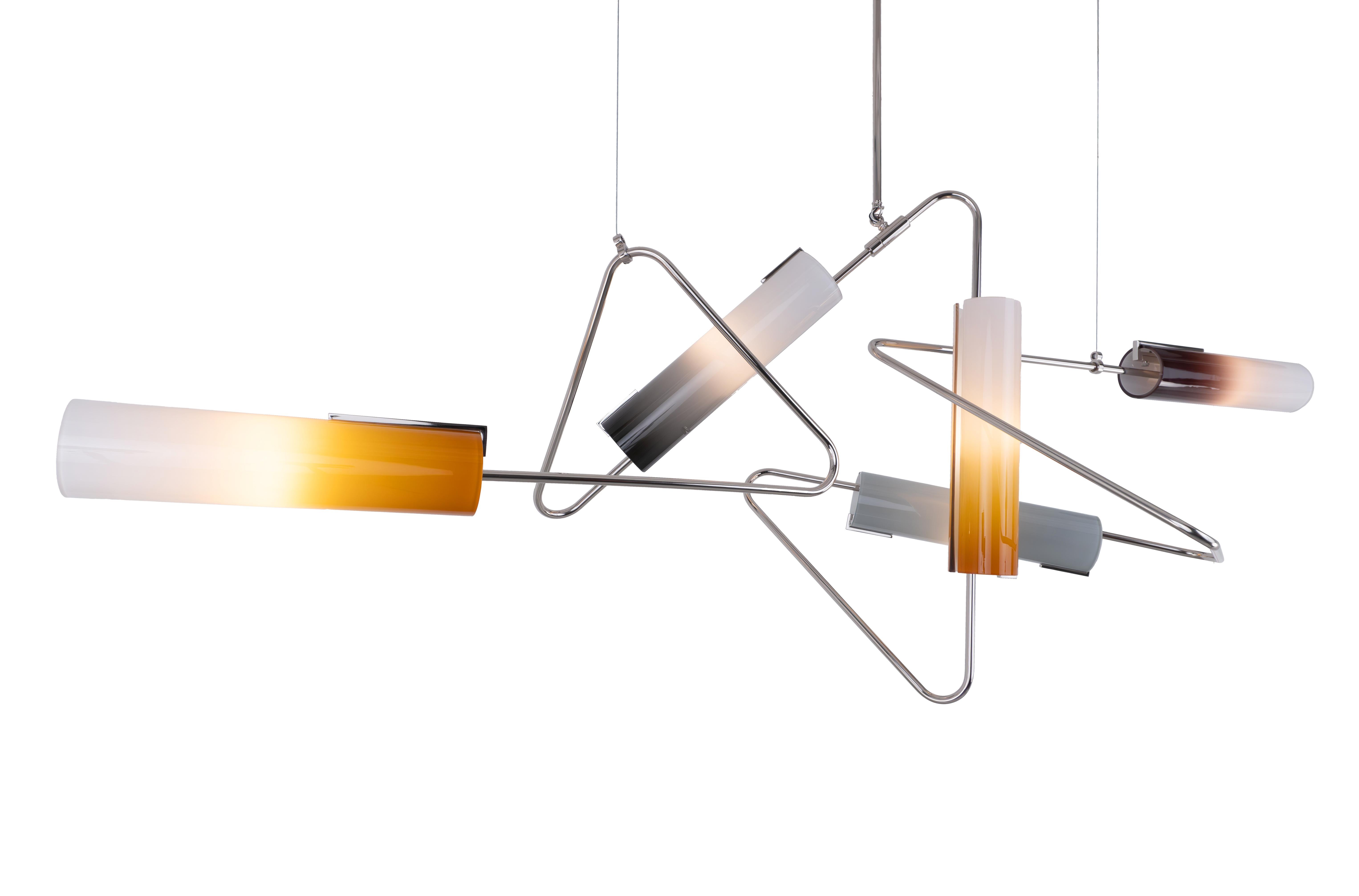 The Continuum Collection was inspired by New York’s vibrant street art. The structure utilizes custom bent tubes that can be connected and arranged in a variety of ways to produce a multiple styles and sizes. The hand blown glass shades are