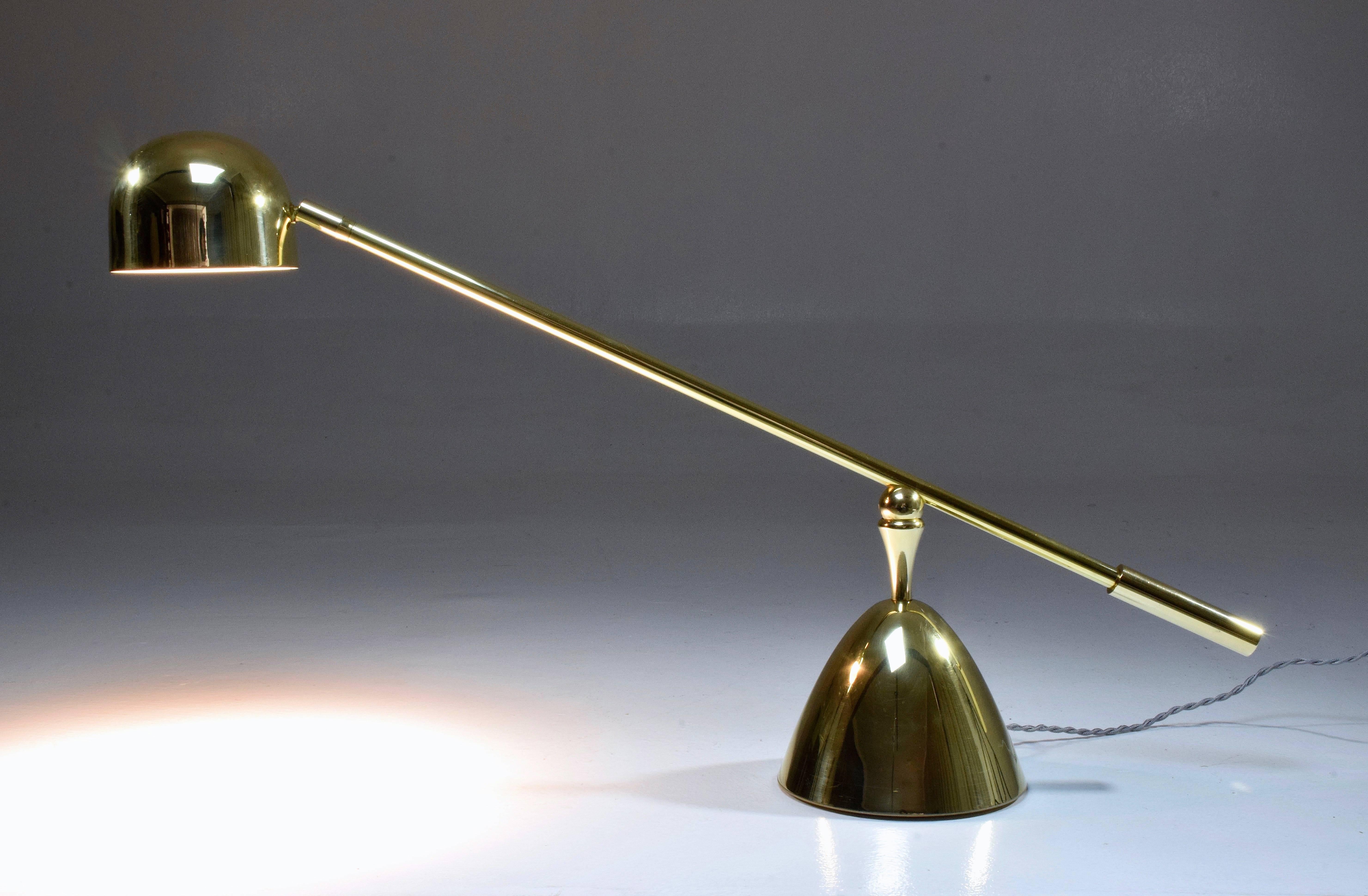 Contemporary handcrafted desk or accent lamp composed of a solid polish brass structure and designed with an adjustable stem and a rotatable shade. This piece rotates around two axis: the shade and the base. The Continuum-I Model I is part of the