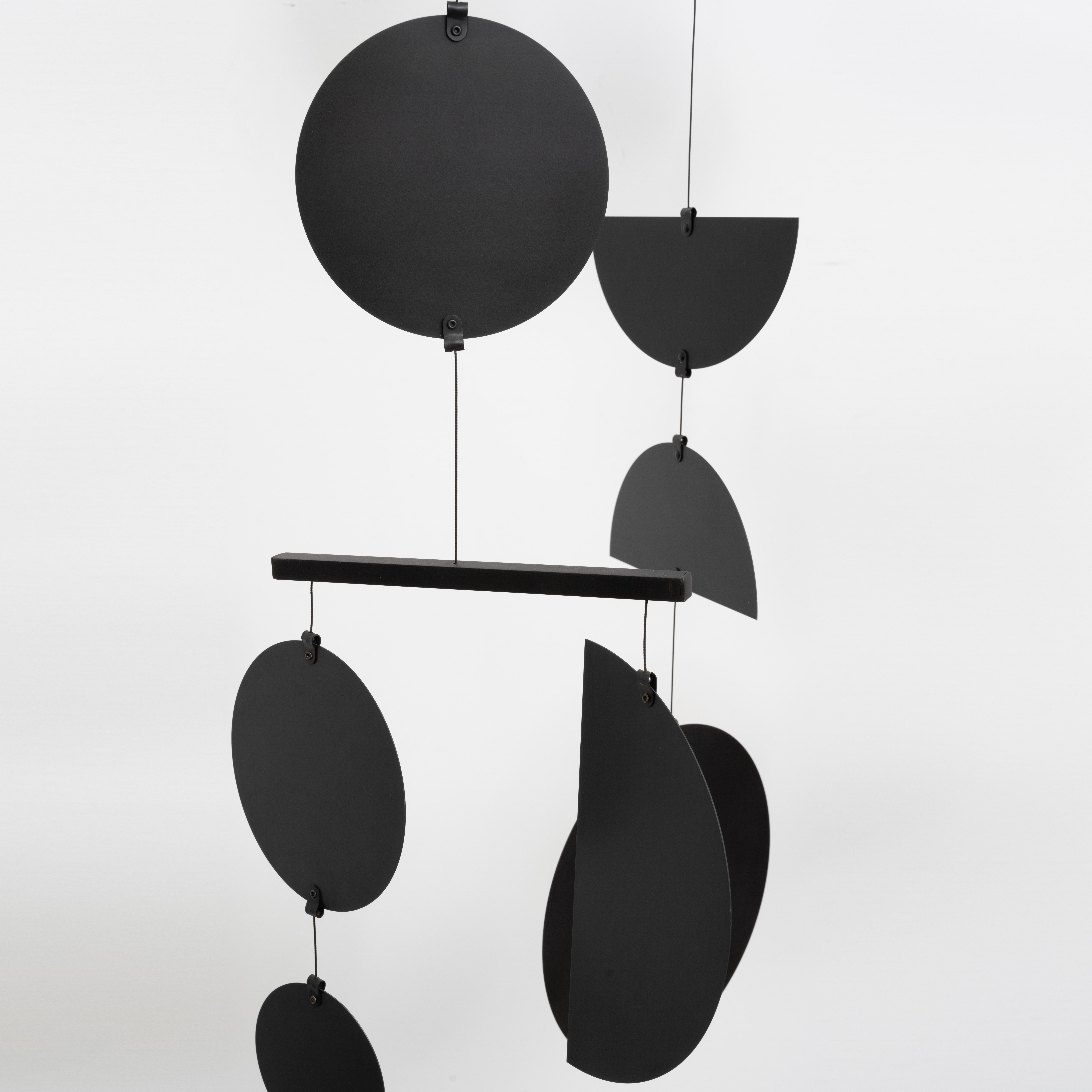 The Continuum Mobile is our most stunning mobile in both design and scale with visually cacophonous clusters of shapes that artfully glide between each other. The striking black patina adds depth and a graphic finish to this kinetic mobile. This