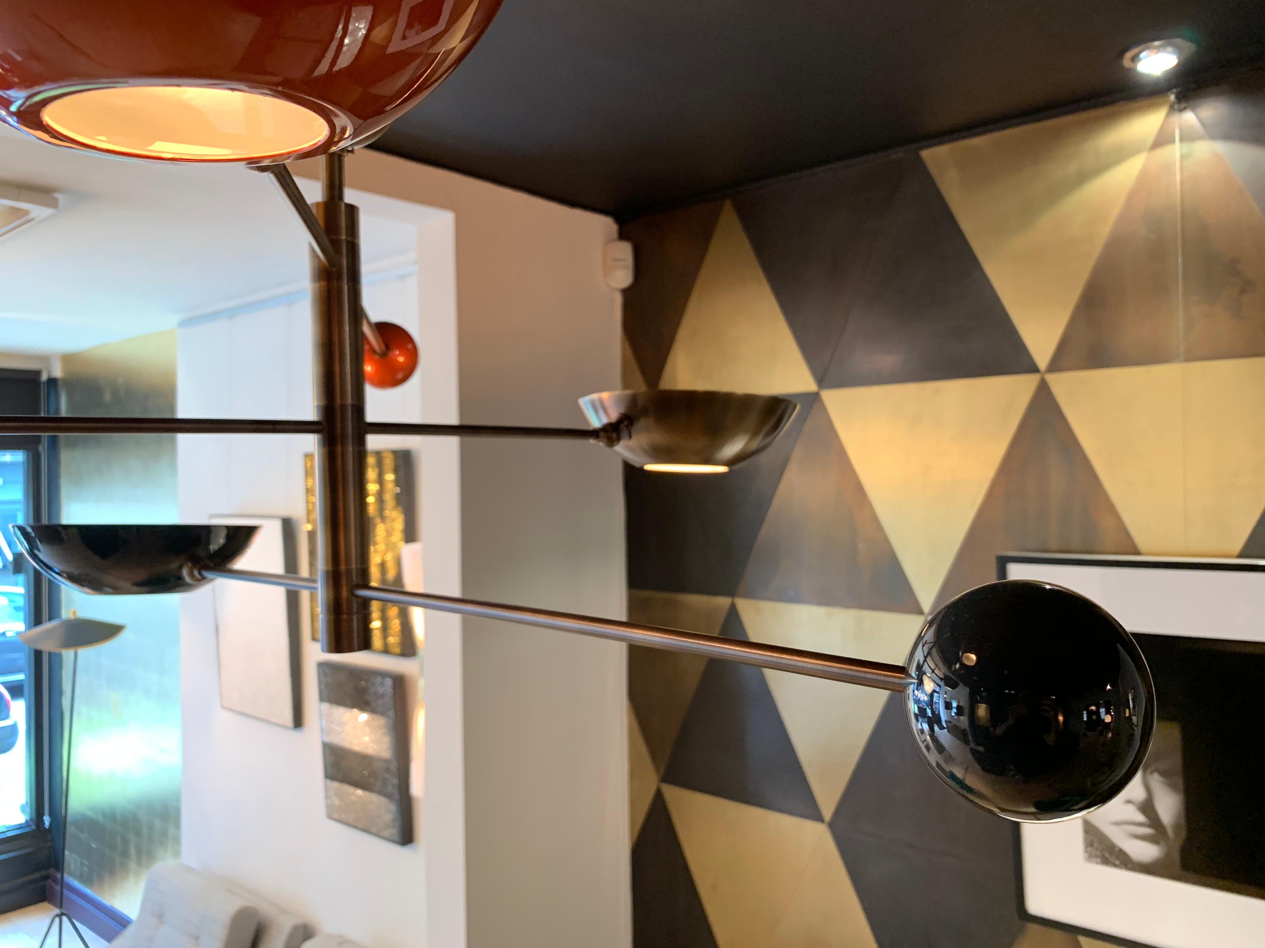 A customised version of our popular Contrapesi pendant, this demure version has grey and orange cups and counterweights on a bronze patinated brass frame.

Set to a total drop of 40 cm, this pendant is ideal for rooms with a lower ceiling.

This