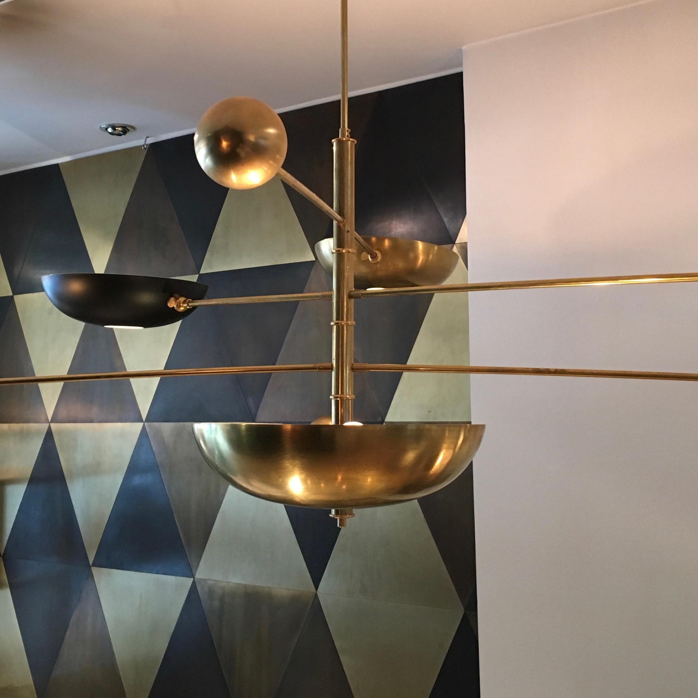 Four-tier midcentury style pendant, inspired by Stilnovo. 

Recreated in Italy by artisans using the same materials and techniques as the original manufacturers, each cup is counter-balanced by a hollow ball, weighted with metal beads which can be