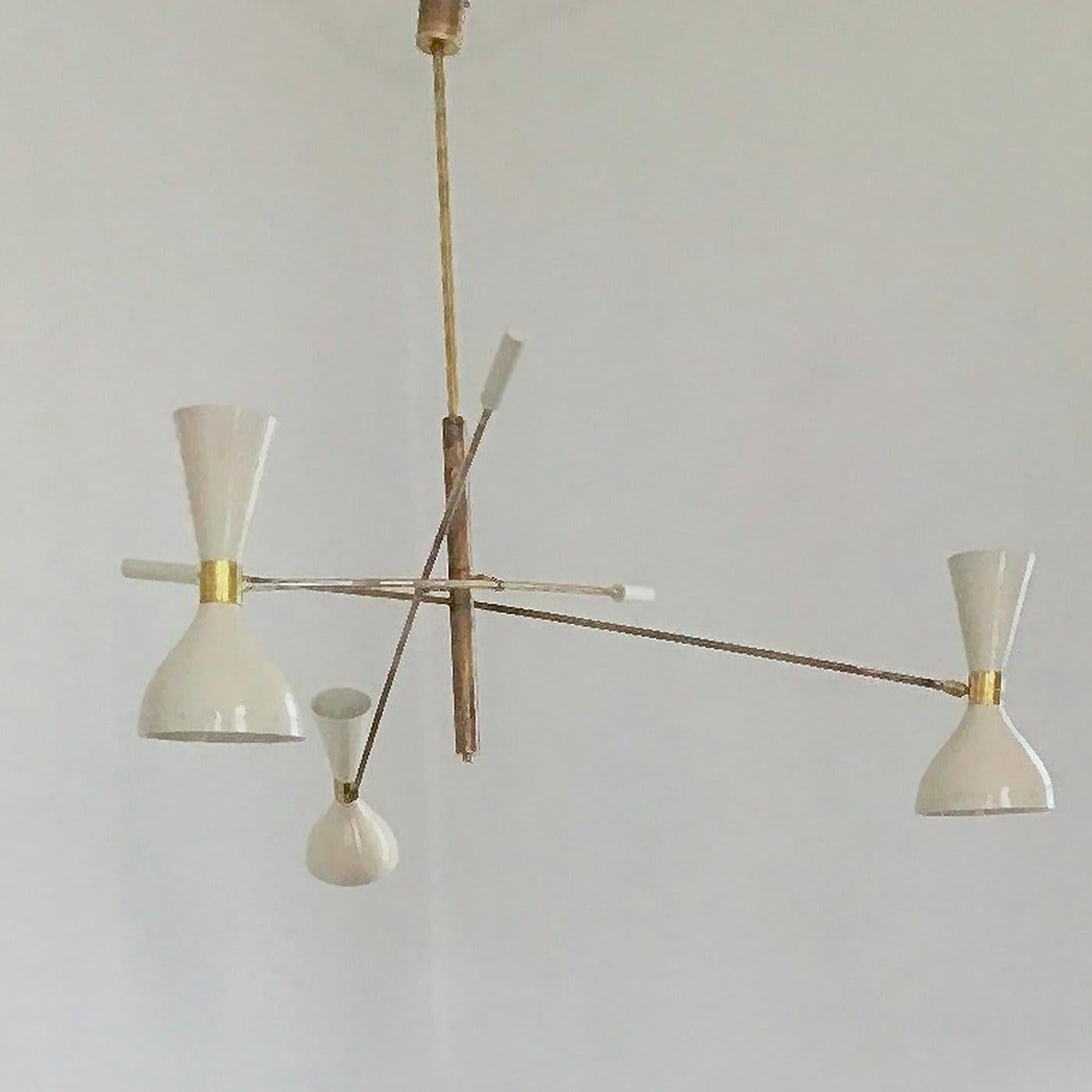 A magnificent interpretation of mid-century style, this three-arm chandelier combines the warm glow of natural solid brass with the ivory-hued aluminum of its three double shades. This unique structure features counterweights to adjust the position