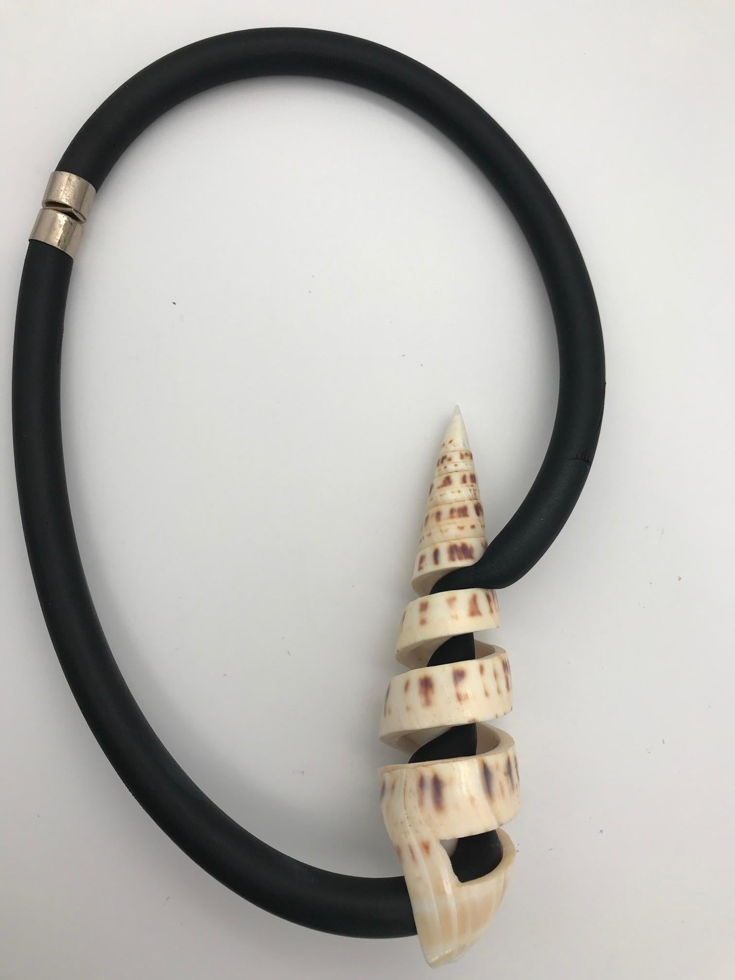

This piece is a Single Shell Corkscrew Necklace.  Designing with small and medium shells takes a special effort. Because of the financial viability of pearls, pearly oysters  will continue to be produced in ponds with appropriate conditions. This
