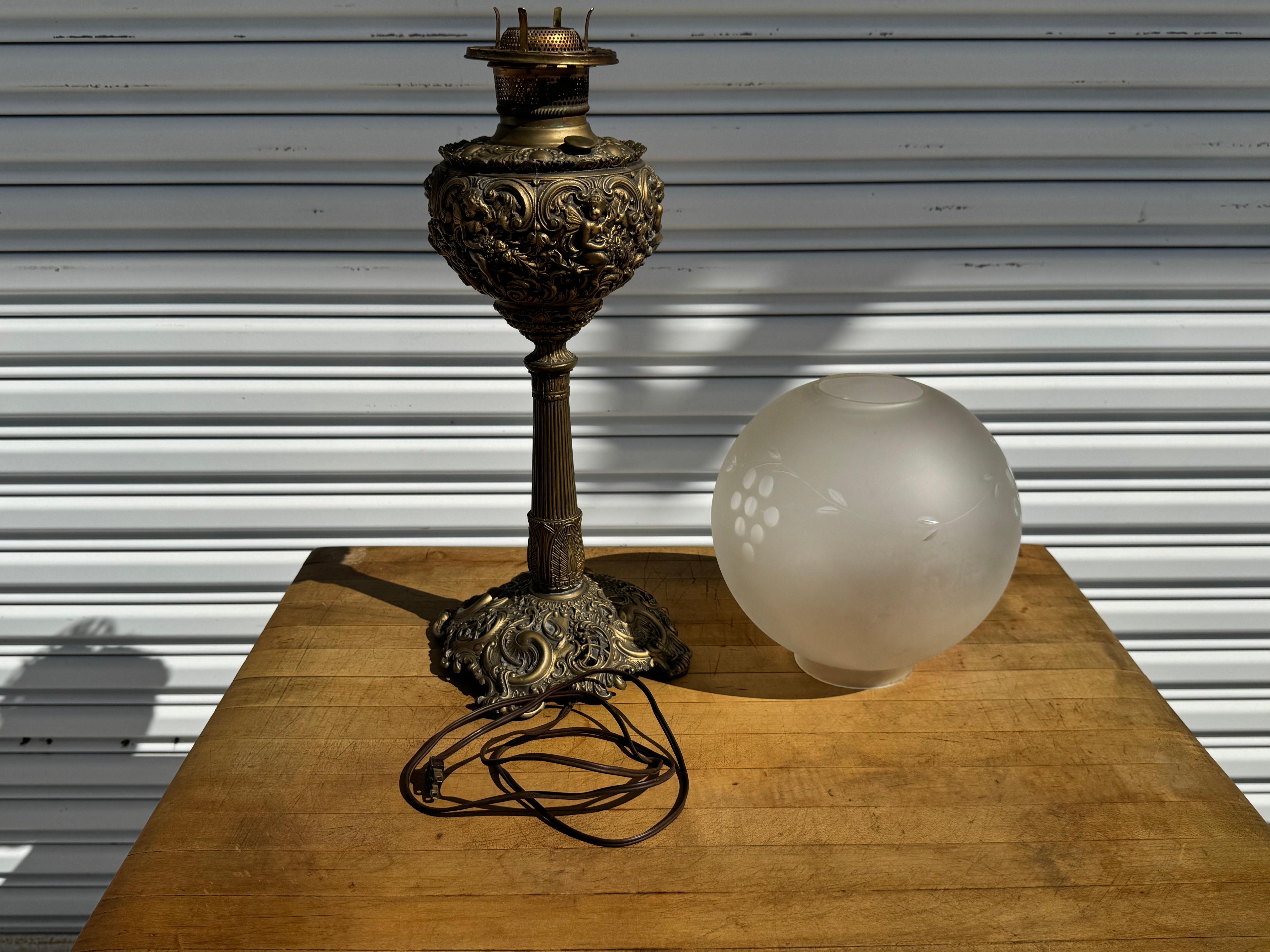 This late Victorian Lantern was converted to a table lamp.
Its very ornate in a late Victorian period style.
It has a nice etched glass globe shade.