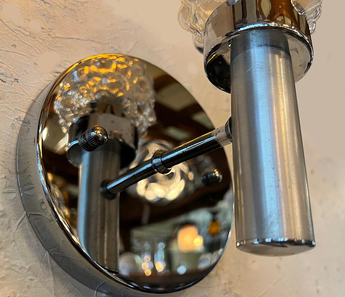 Mid-Century Modern, chrome wall sconce pair, from France.
Completely rewired and adapted for US use. This cute pair of wall sconces are both chrome and brushed chrome on different areas of the light, by design. Unique bubble glass shades suggest a