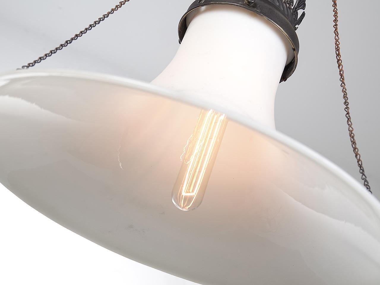 This early gas lamp features a rare milk glass elongated trumpet shade. The look is very unique. When converting to electric we were able to save the original gas valve and pull chains. 