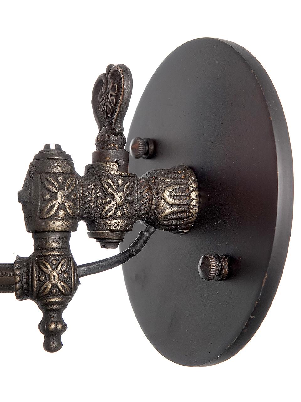 This is a beautiful original pair of gas Wall lamps that were carefully converted to electric. They are jointed to swing side to side. The shade are a Tulip shaped are glass. The shades are unsigned but look like Steuben. The arms are covered in