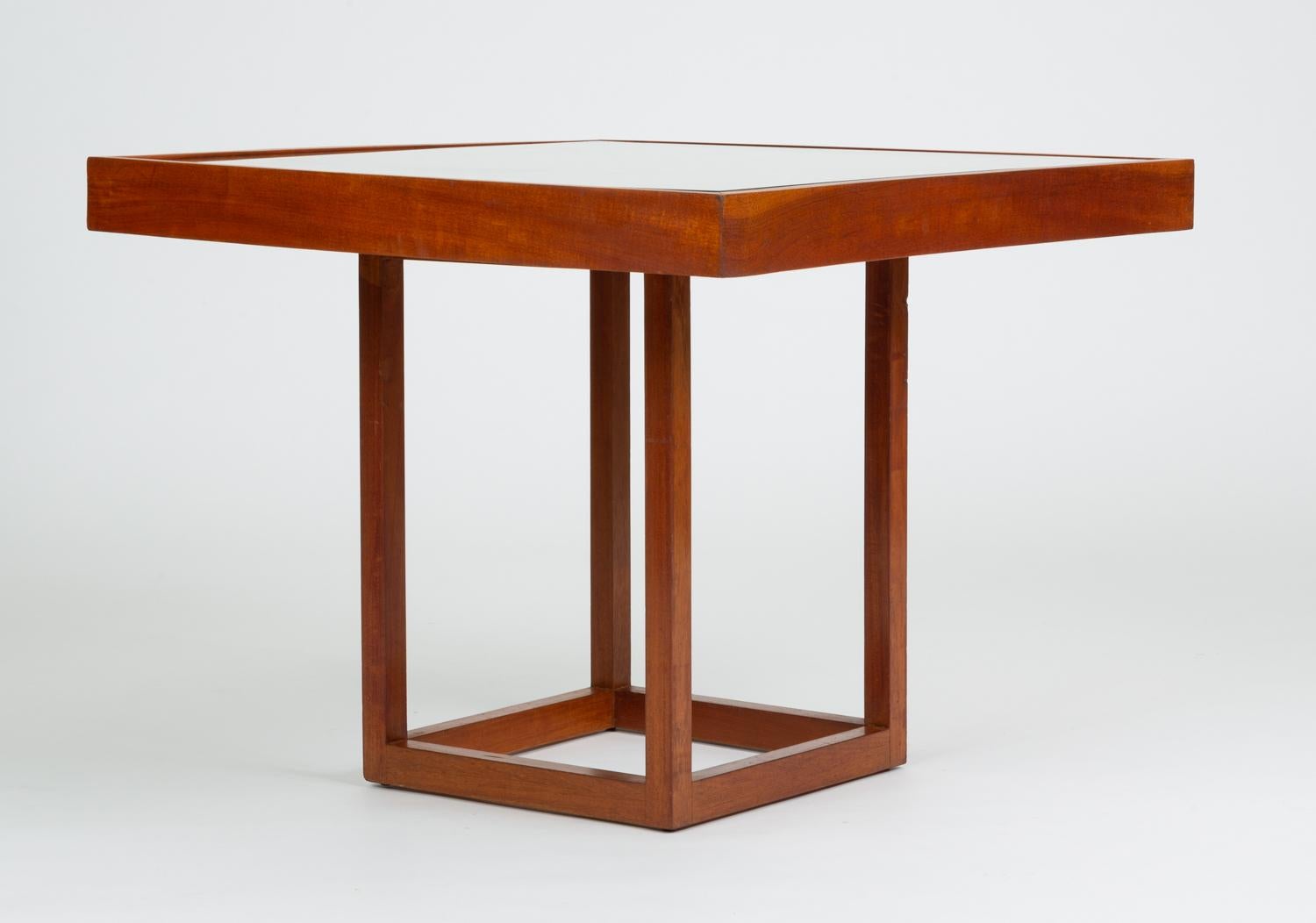 Bauhaus-trained, Mexico City-based Michael van Beuren created highly functional modern design inspired by Mexican vernacular styles and materials. This example is a convertible table with a teak frame and and irregular shape with concave and convex