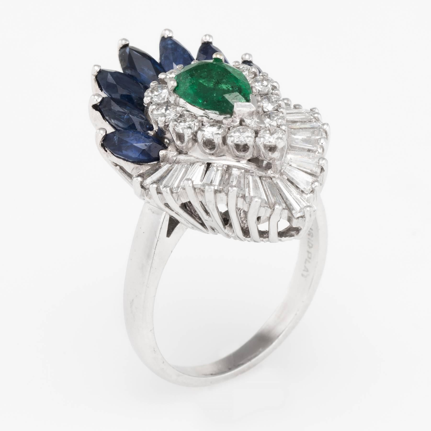 Finely detailed convertible cocktail ring to a pendant (circa 1950s to 1960s), crafted in 900 platinum. 

Centrally mounted emerald is estimated at 0.60 carats, accented with an estimated 1.75 carats of blue sapphires and 1.50 carats of round