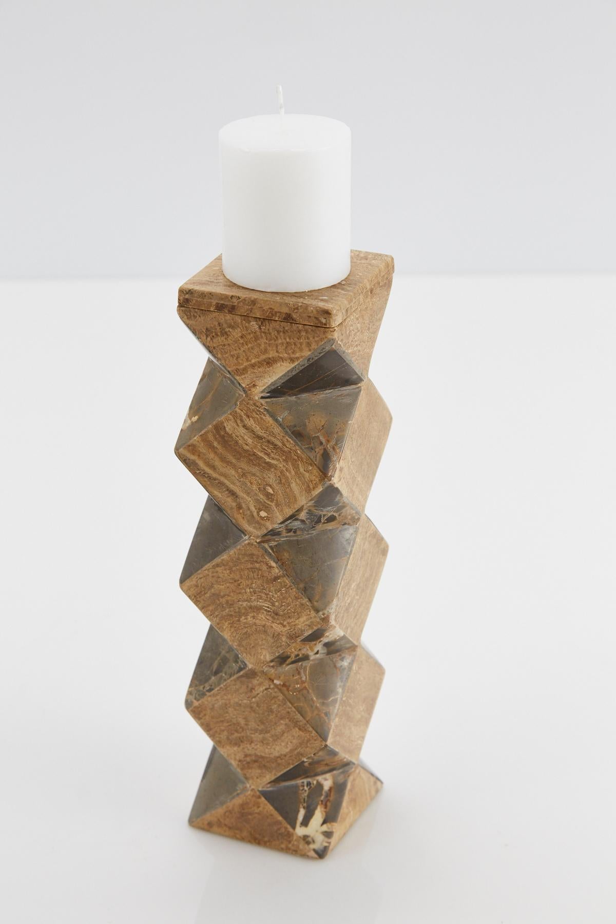 Medium-sized pillar candleholder. Body is comprised of a rectilinear cube with faceted sides, alternating snakeskin stone and beige tessellated stone. The top of this convertible candlestick is removable and can then be used as a vase.

Coordinating