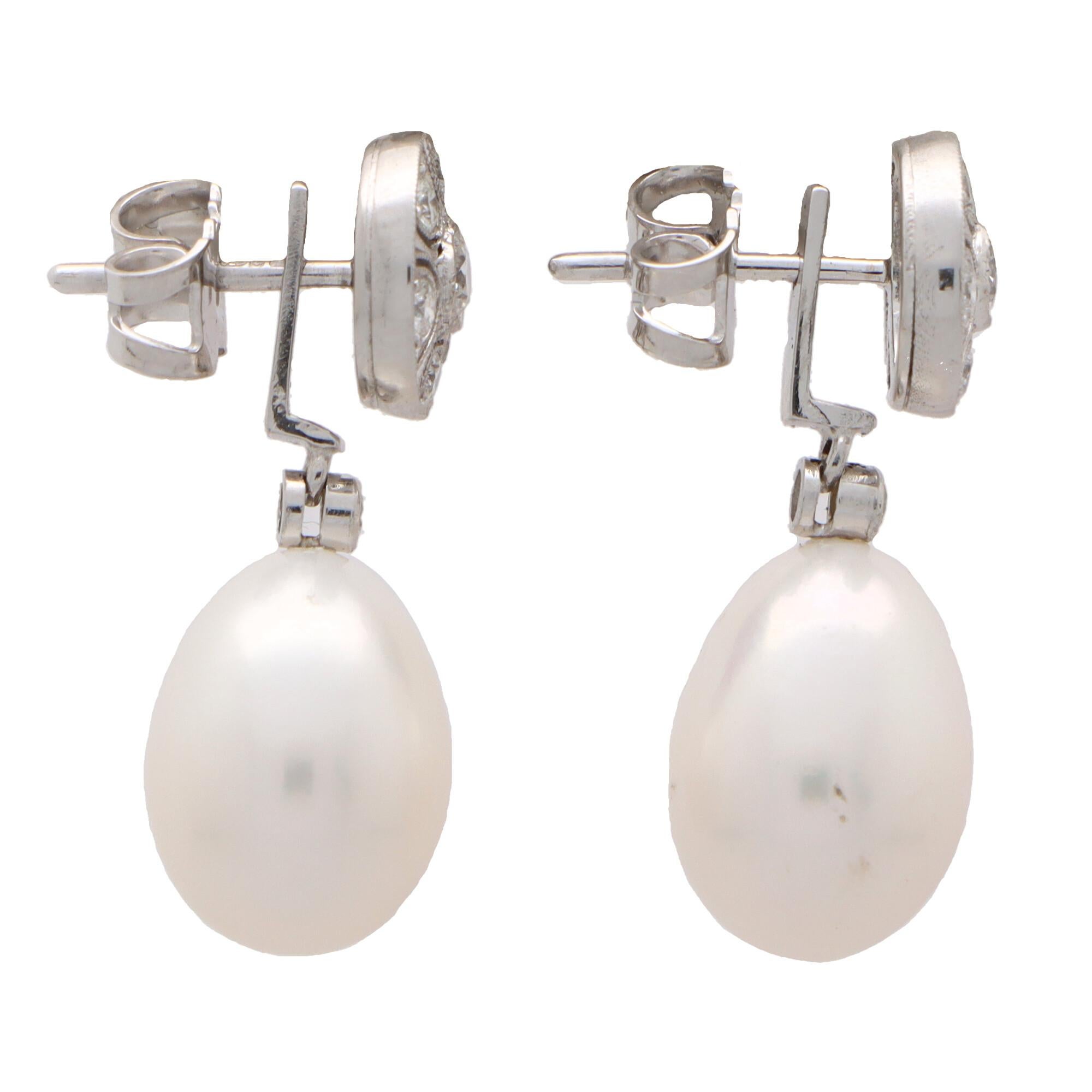 A beautiful pair of convertible pearl and diamond earrings set in 18k white gold.

Each earring is firstly composed of an openwork diamond cluster stud set with exactly 7 round brilliant cut diamonds. Hanging from this stud is a 9 x 12-millimetre