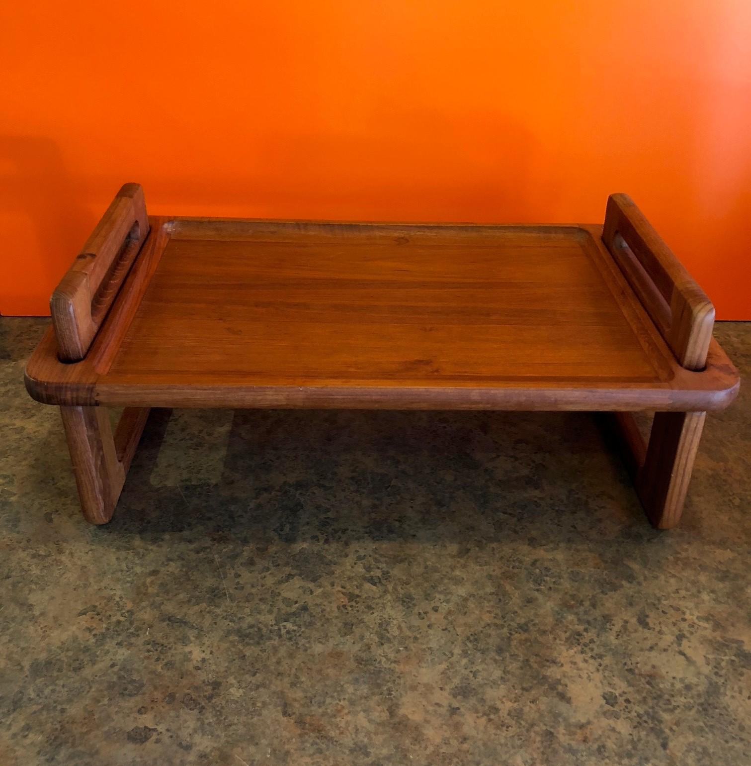 A very nice convertible breakfast tray made of teak wood by Dansk, circa 1970s. The two support legs are removable allowing the tray to function as a flat tray. Unique locking ball bearing design.