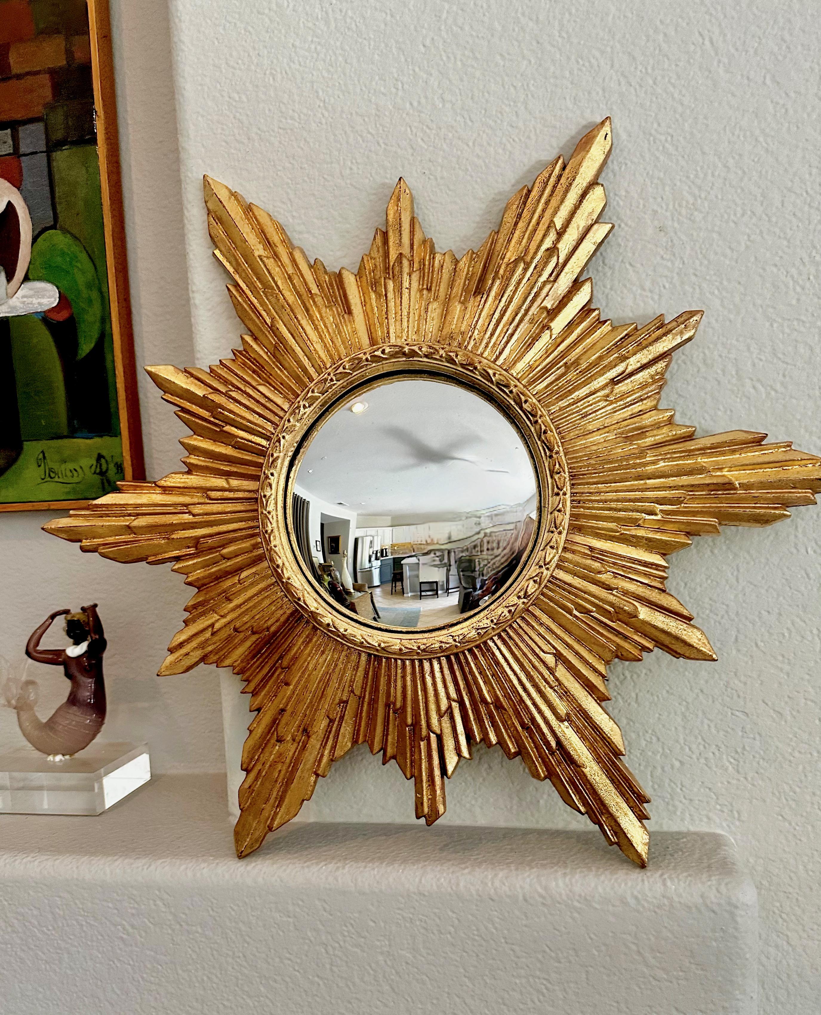 Mid century round gilt finish molded hard plastic sunburst or starburst wall mirror with convex mirror.