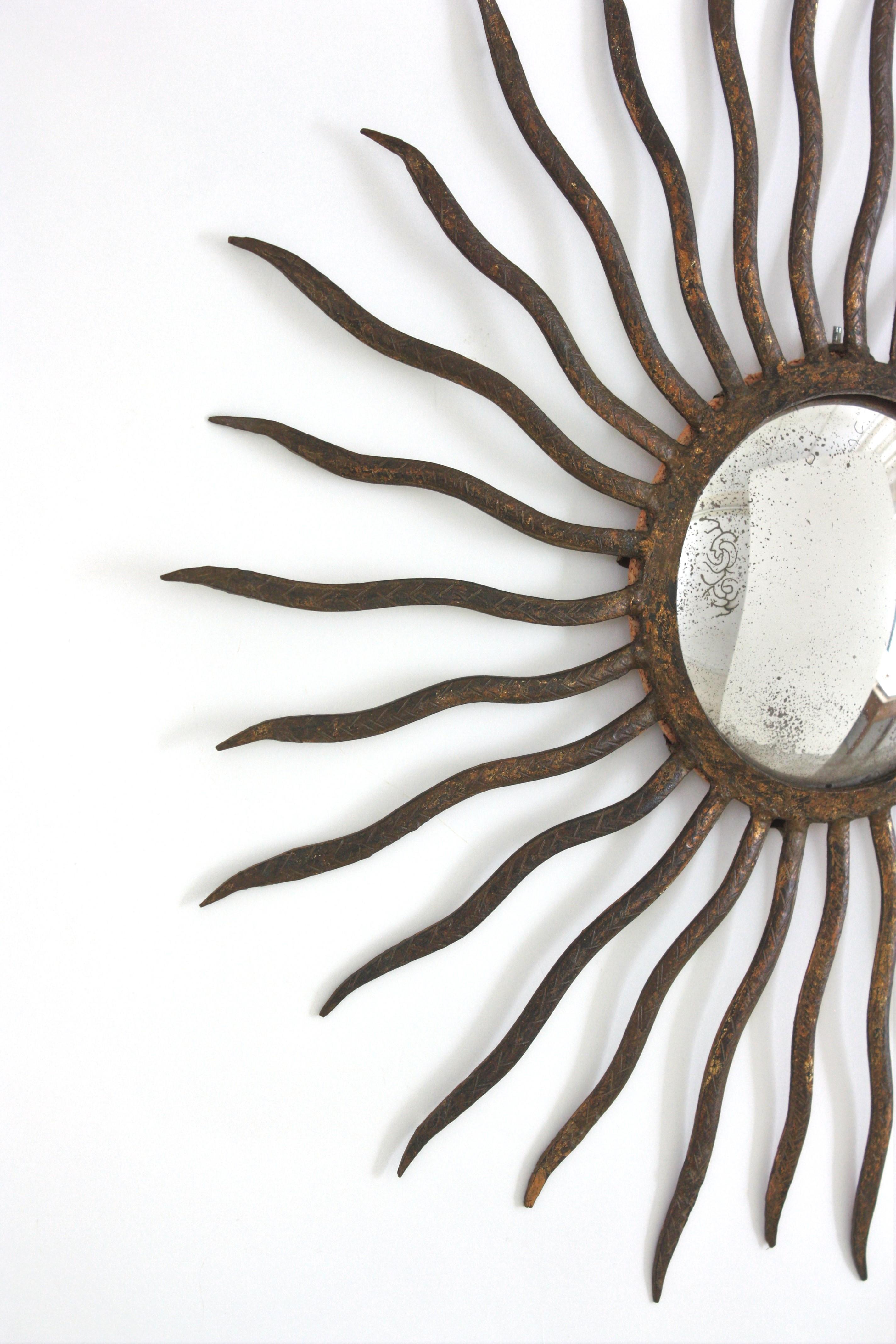 Forged Convex Sunburst Mirror in the Style of Gilbert Poillerat, Parcel Gilt Iron, 40s For Sale