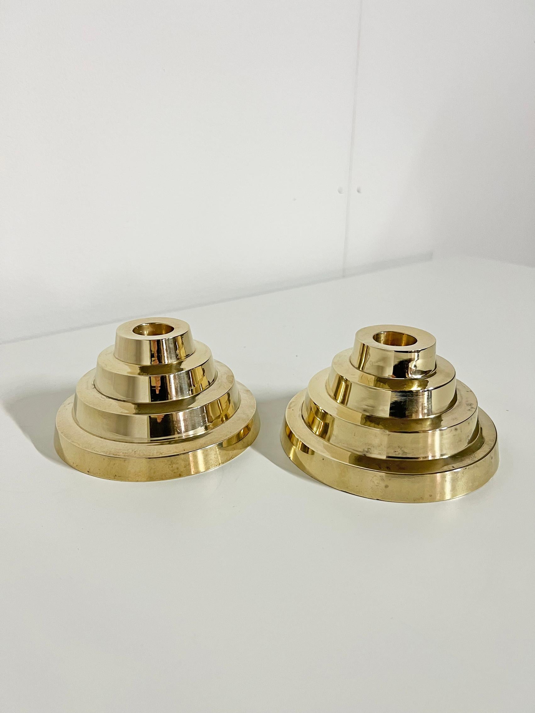 Very cool set of two candleholders in brass. 
Unknown designer, unknown producer. 
Good condition, wear and patina consistent with age and use.
Brass patina with some dark marks as seen on the last three pictures. 
