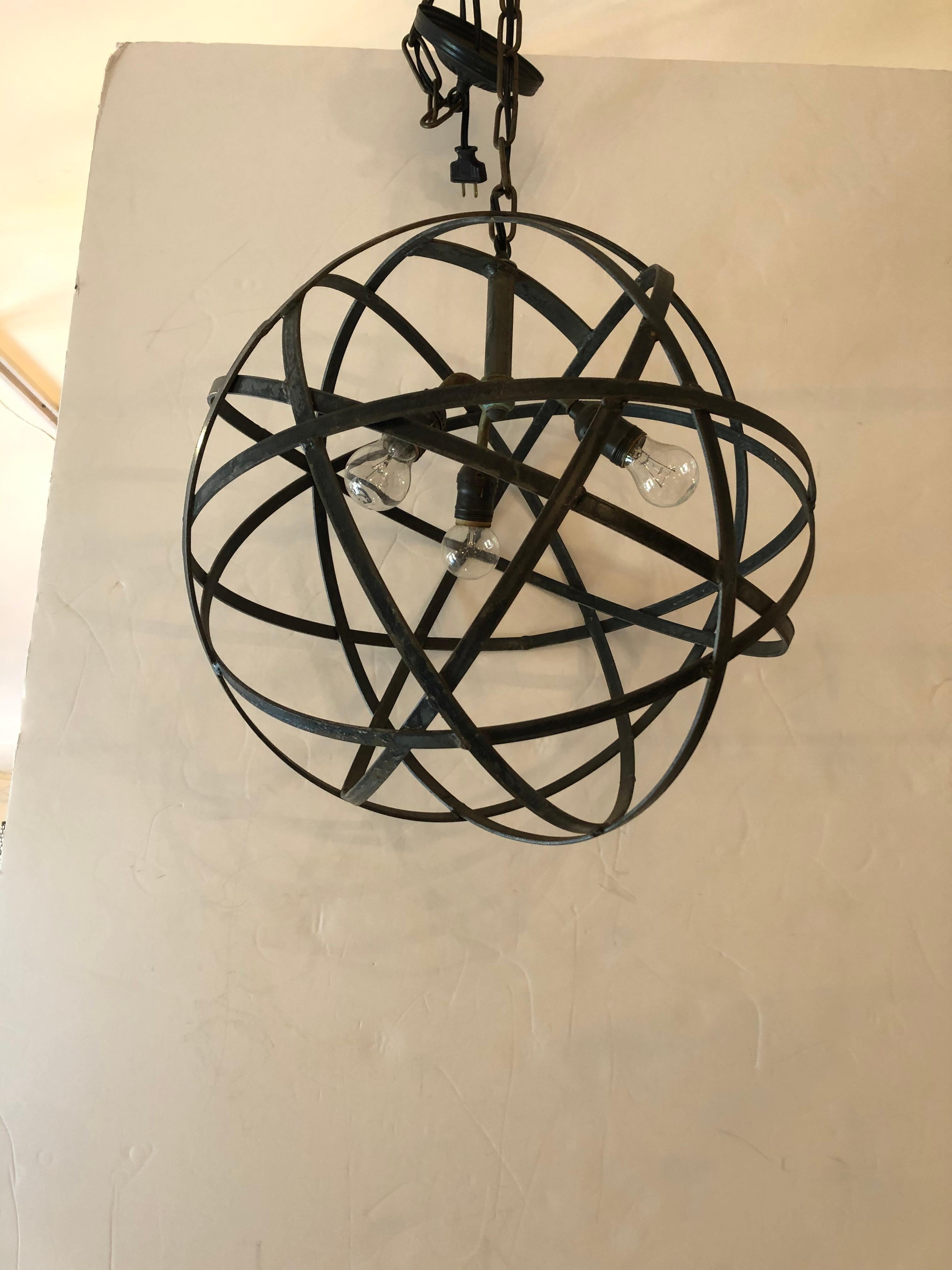 Super cool vintage industrial spherical orb chandelier having bands of overlapping steel and 3 interior sockets with great pipe design.
30