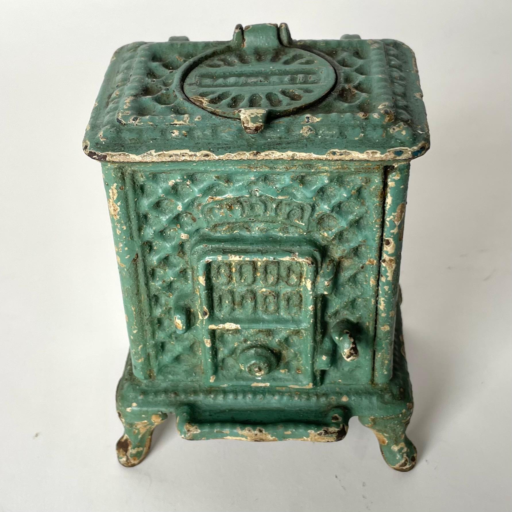 Cool Ink Well designed as a Godin iron stove from the late 19th Century. Made in France in cast iron and painted with a beautiful patina. Probably an advertising item from late 19th Century. The ink holder in glass with small chip (see