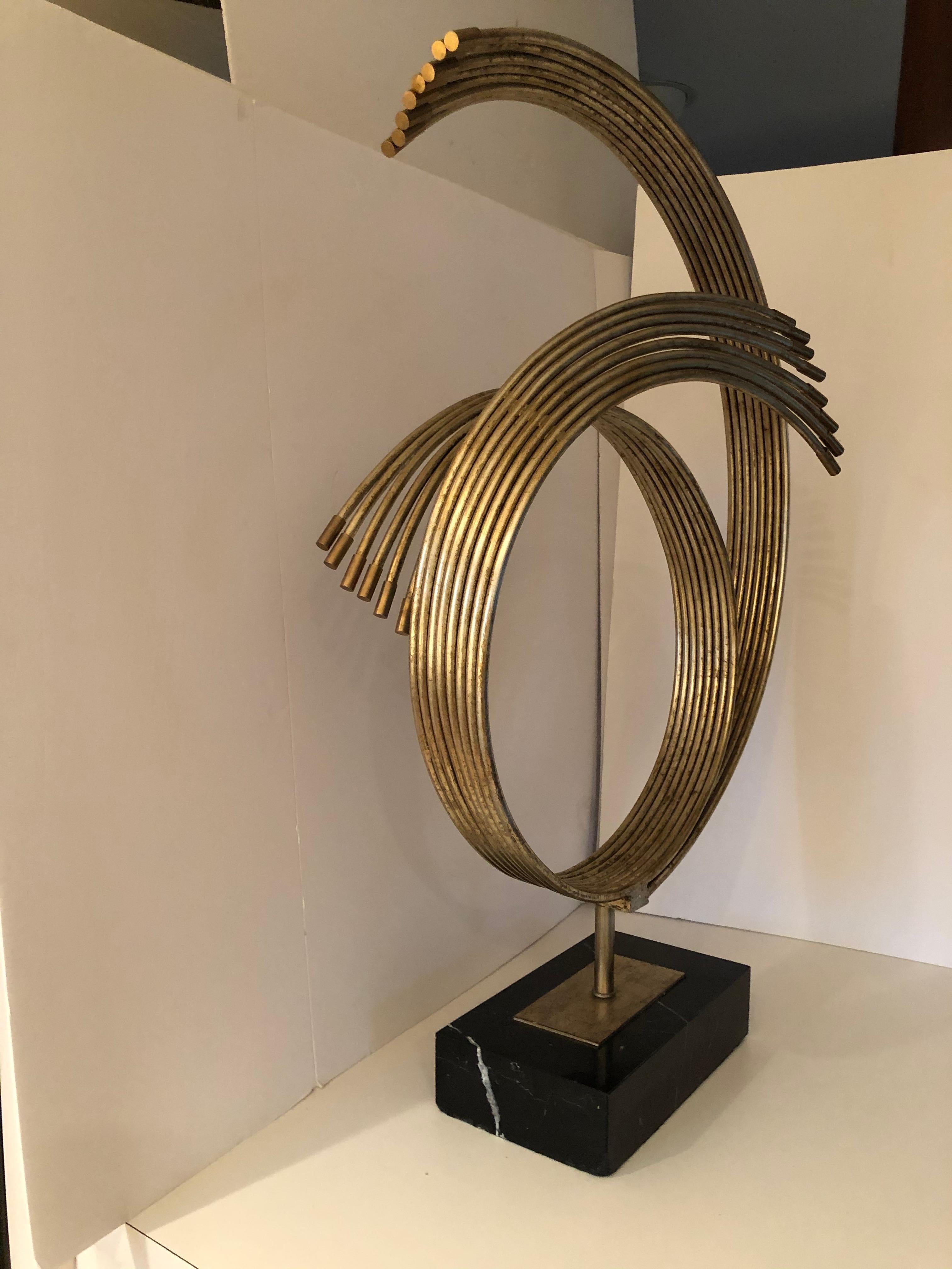 A dramatic Mid-Century Modern sculpture by renowned artist, Curtis Jere. The brass sculpture has great size and movement and is mounted on a black marble base.