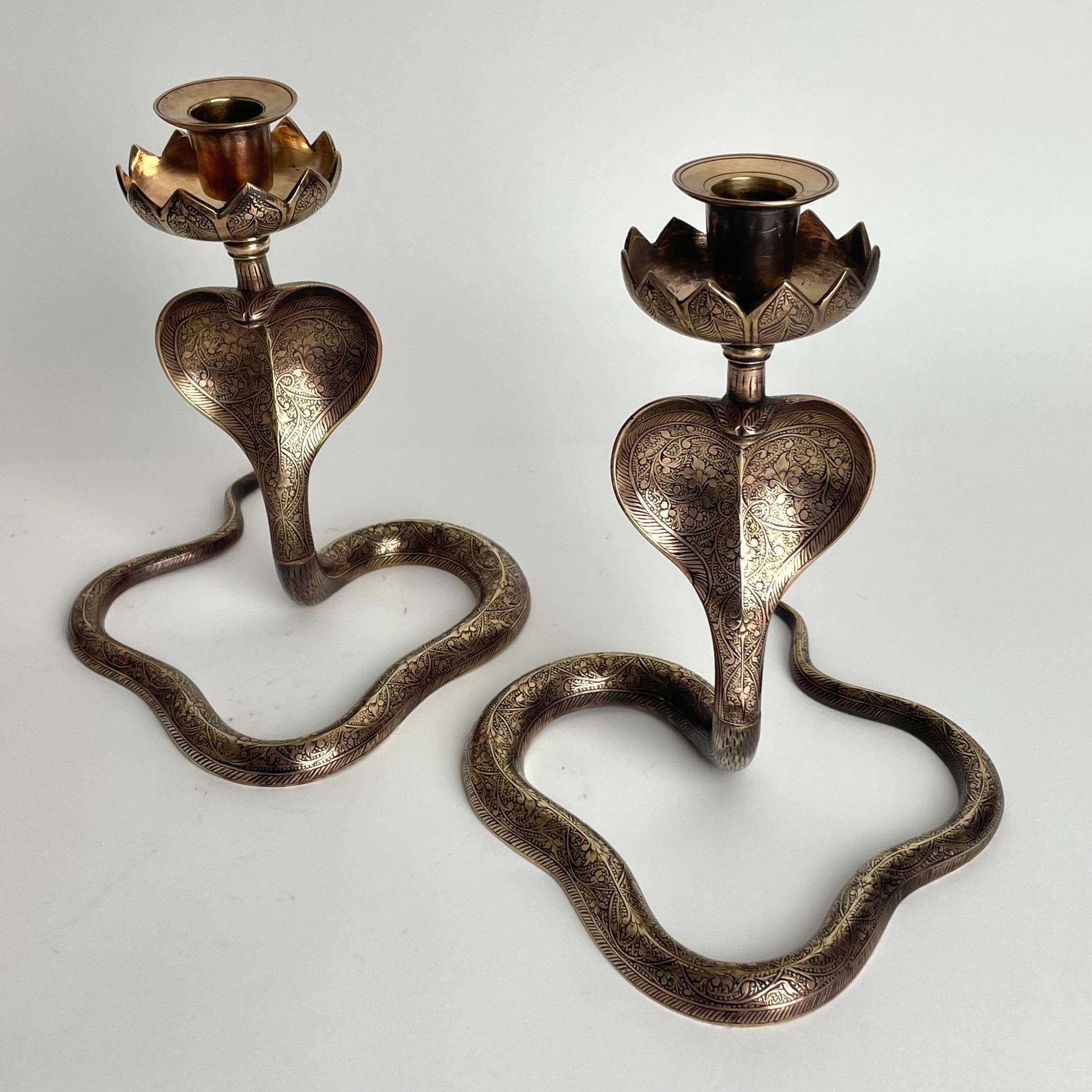 A very cool pair of Brass Cobra Candlesticks. Probably made in India during the 1930s. Fine craftmanship with rich decoration of flowers and leaves.

Wear consistent with age and use.