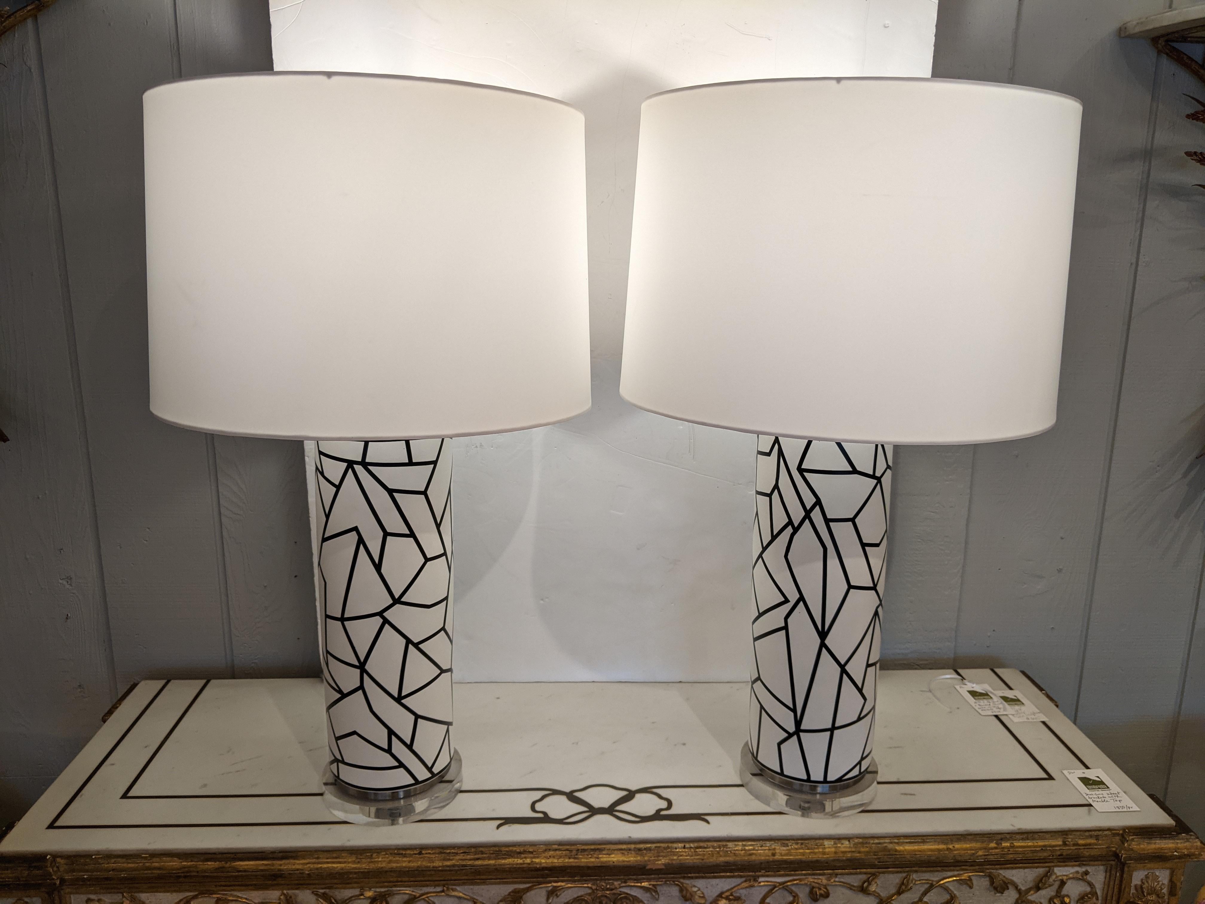 Cool and striking pair of large columnar table lamps having fascinating abstract black on white design. 
 Shades included.
Columns are 6.5 diameter, shades 17 diameter.