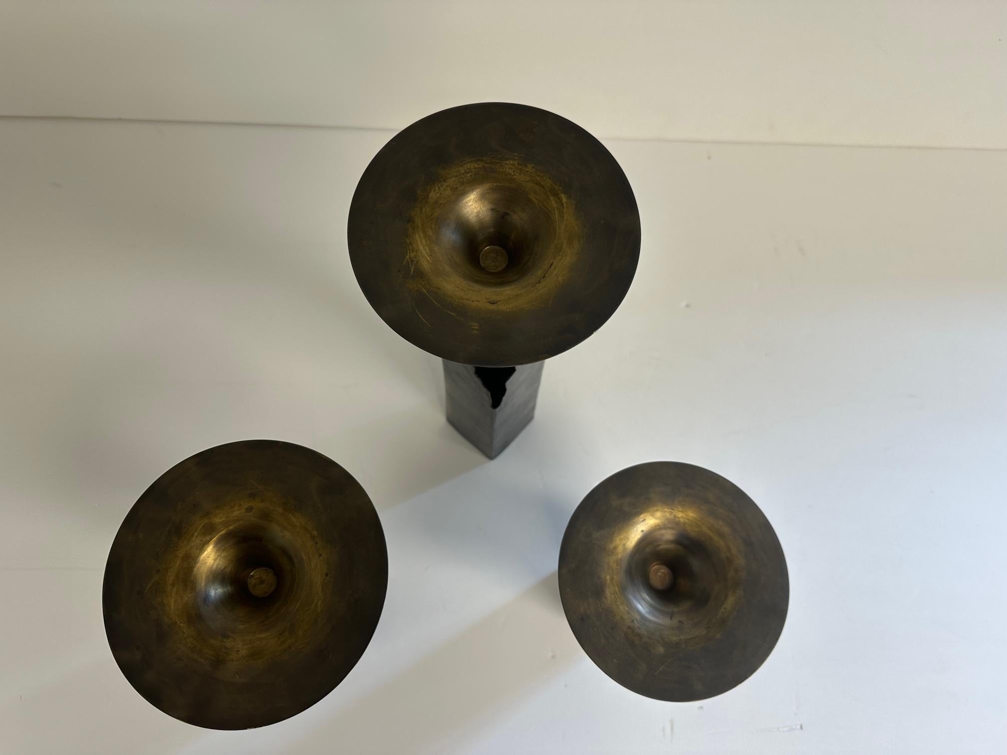 American Cool Set of Graduated Patinated Pierced Copper and Brass Candlesticks For Sale