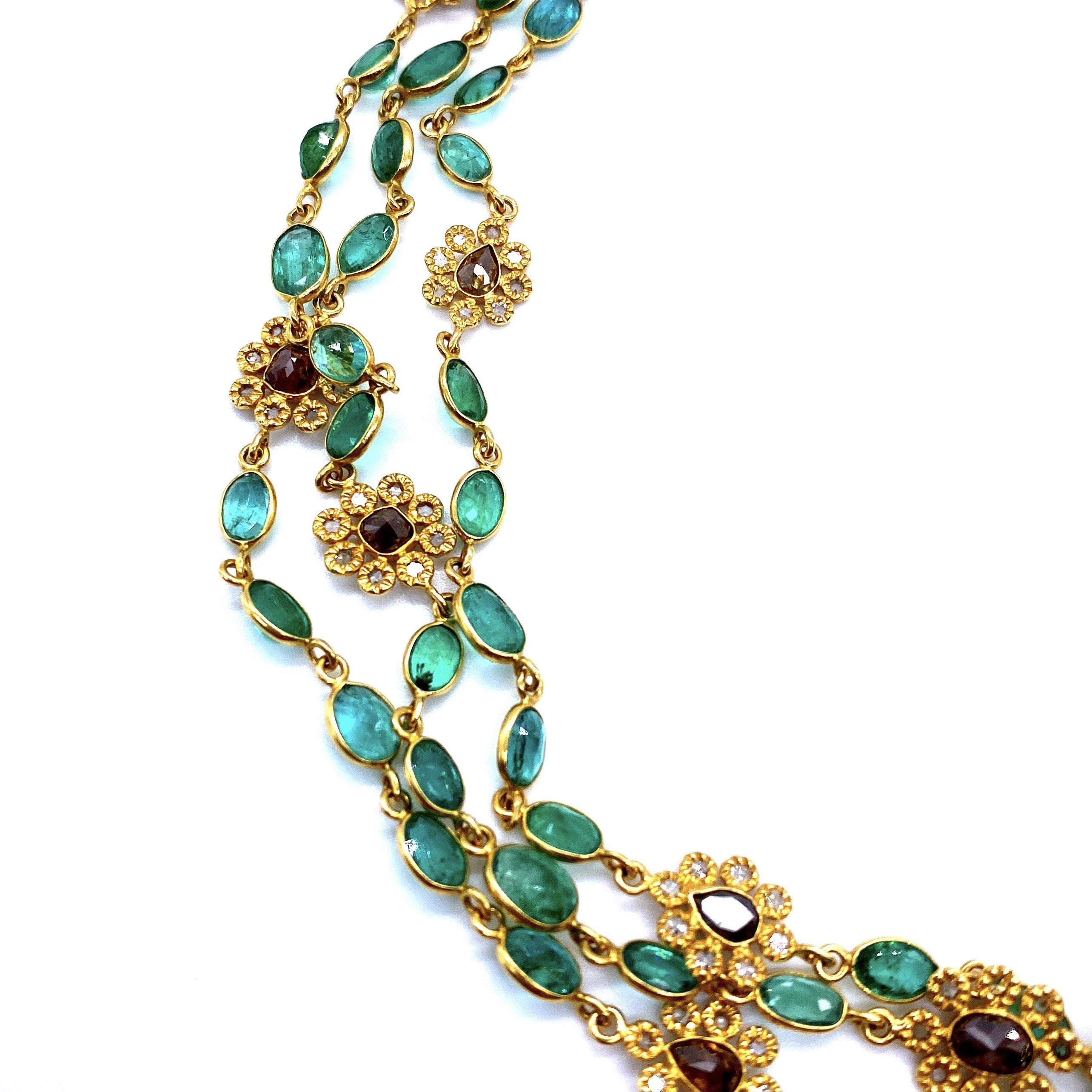 Affinity Long Necklace set in 20K Yellow Gold. Emerald 44.11cts, and 12.56cts Diamonds with brown diamonds in the flowers. Necklace measures at 52 inches.

44.11cts Emerald 
12.56cts Diamonds 
52 Inches 
20K Yellow Gold 