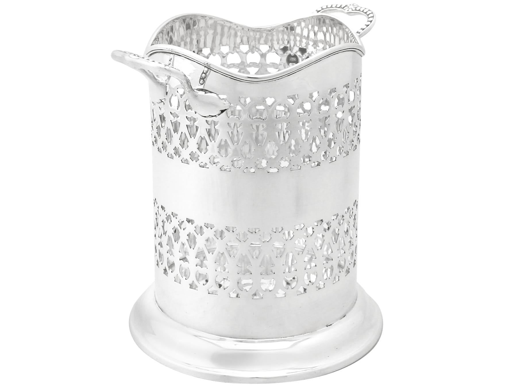 An exceptional, fine and impressive antique George V English sterling silver bottle coaster; an addition to our ornamental silverware collection.

This exceptional antique George V sterling silver bottle coaster has a plain cylindrical form to a