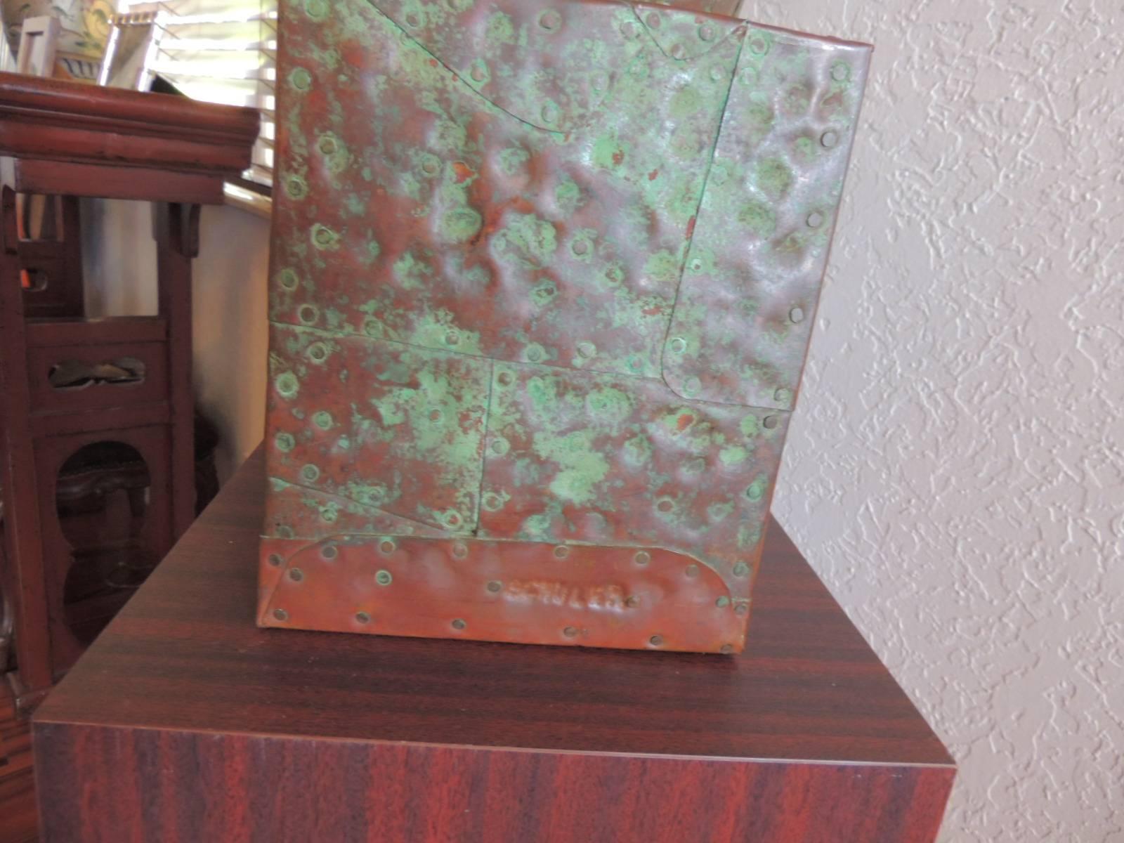 Cooper on redwood sculpture by American Sculptor Melvin A. Schuler on mica pedestal.
A copper over redwood sculpture by artist Melvin Schuler (American, born 1924), circa 1980s. This Abstract sculpture features plates of copper hammered over a