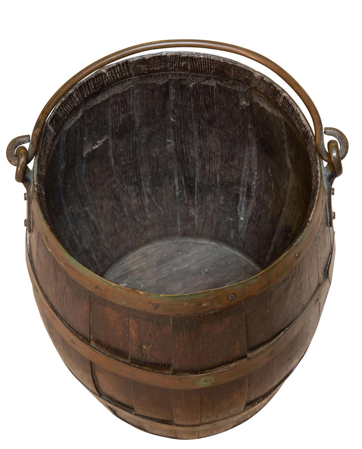 Coopered oak and brass bucket with swing handle,

circa 1900.