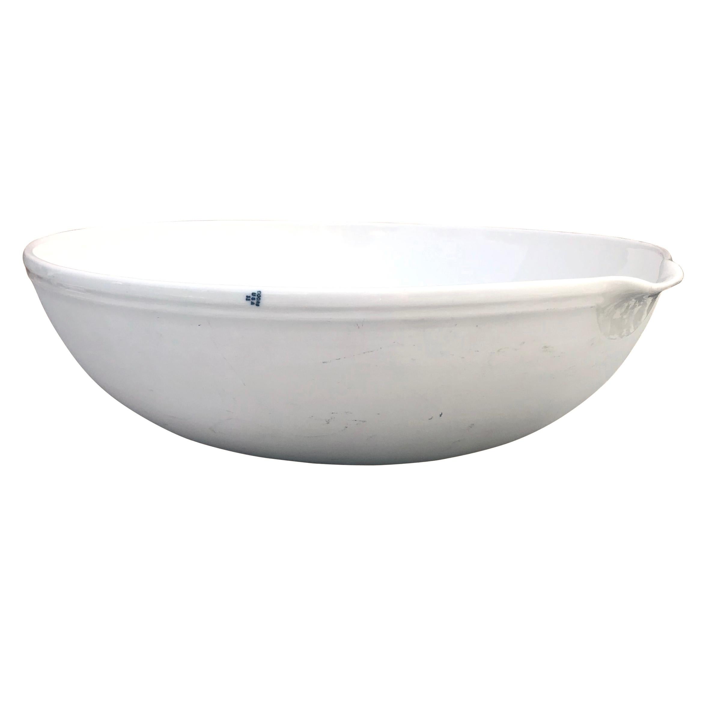 A wonderfully modern early 20th century Coors Porcelain Company evaporating dish with a glazed interior and spout, and an unglazed bisque exterior. An example of this bowl, along with several others, is in the collection of the Museum of Modern Art