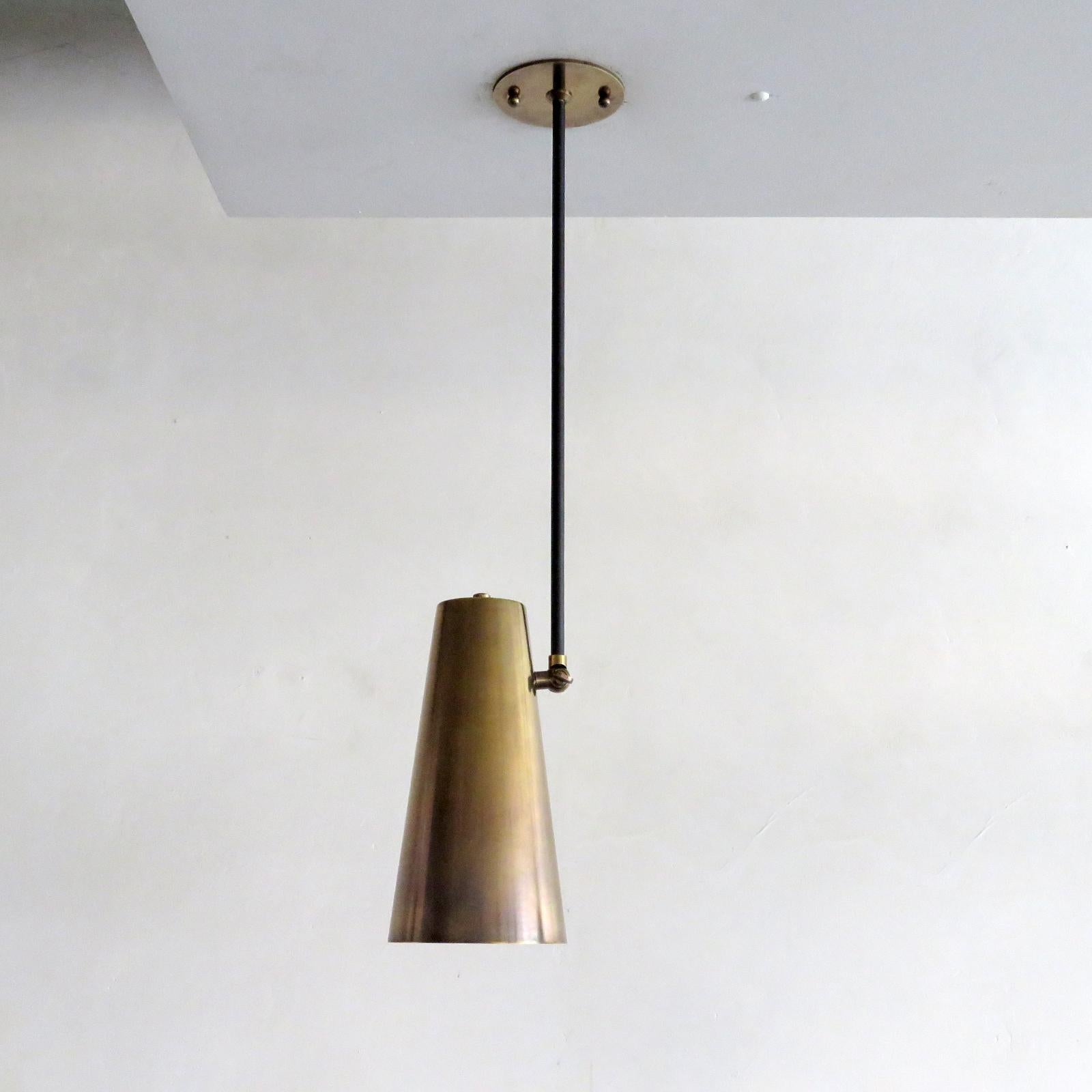 Elegant articulate 'Copa' ceiling lights designed by Gallery L7, handcrafted and finished in Los Angeles from American brass with an aged brass cone on black enameled rod. The cone angle can be adjusted, and the height of the rod is fully