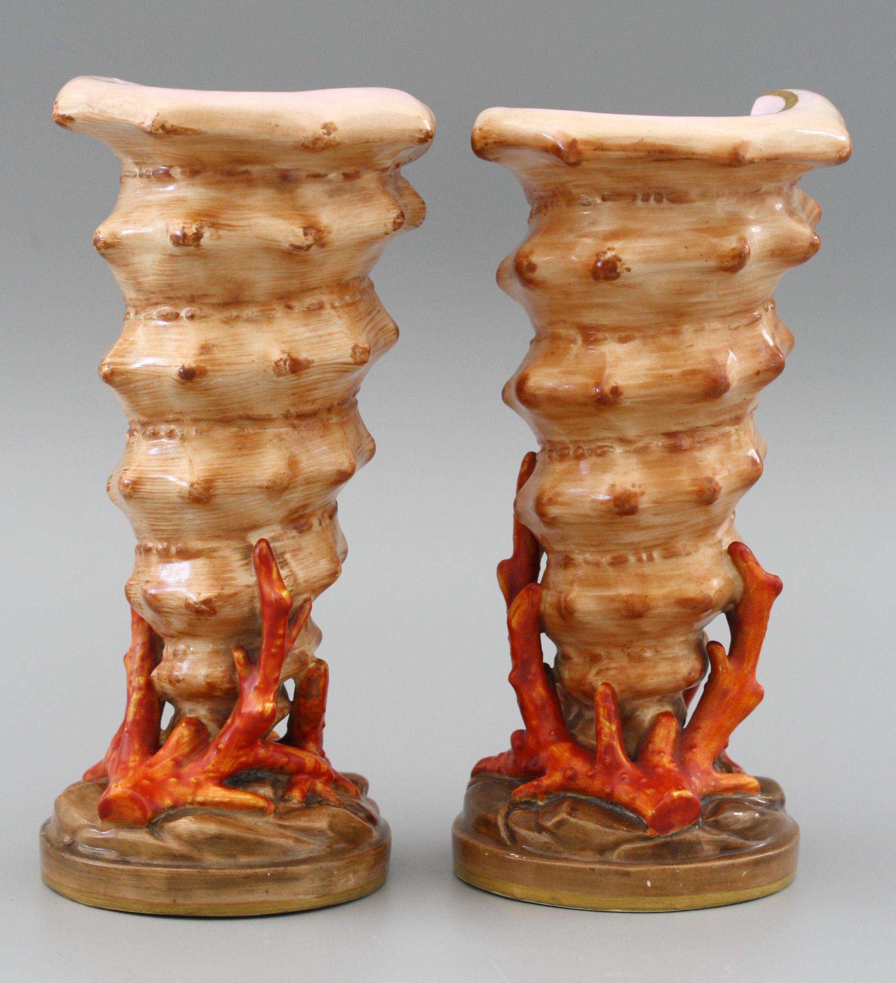 A fine and stylish pair antique Copeland porcelain vases modeled as cornet shaped shells mounted on a rounded base with moulded rocky surface and with coral growing around the bases of the shells. The vases date from circa 1860-1870 and very much